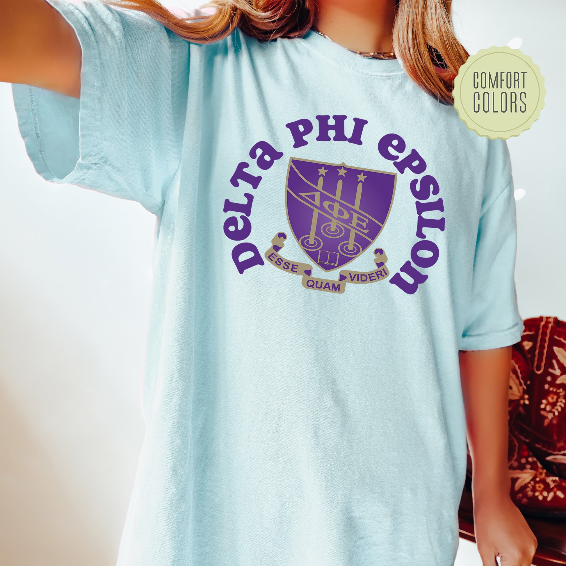 a young girl wearing a blue phi phi shirt