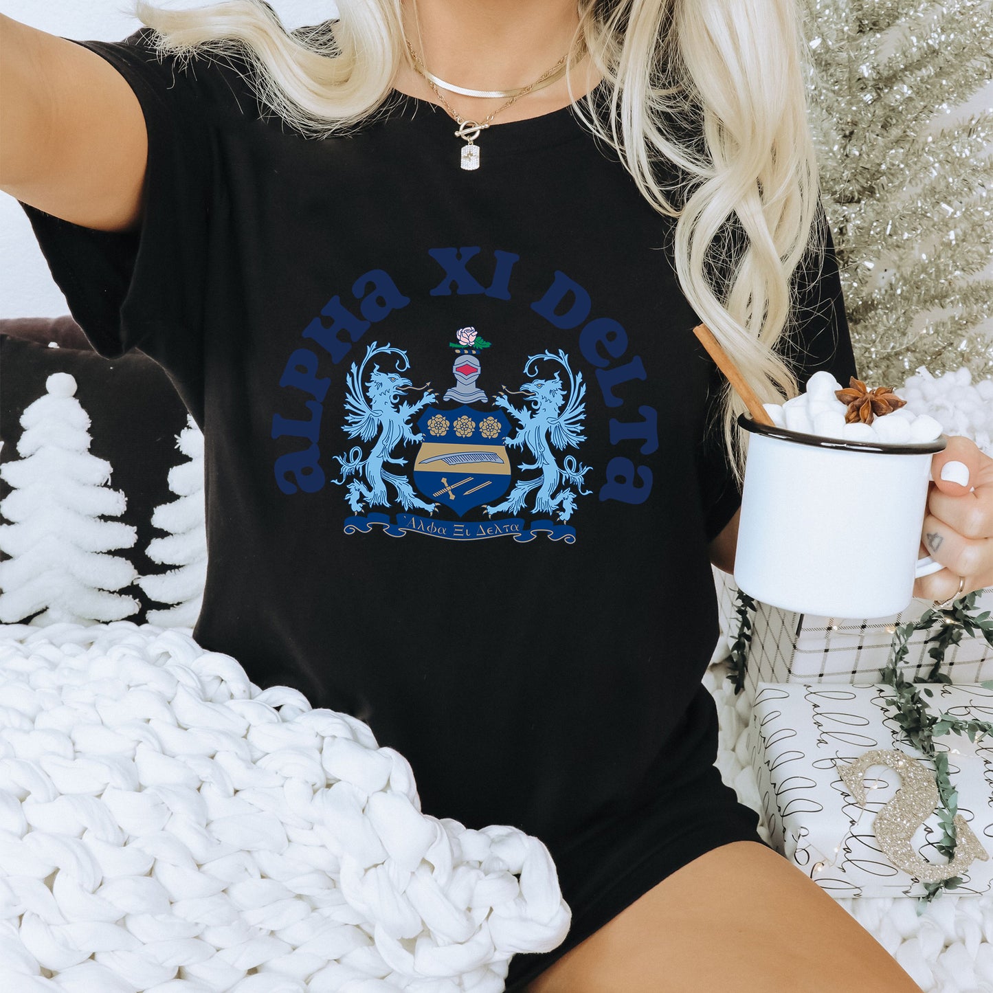 a woman sitting on a couch holding a cup of coffee