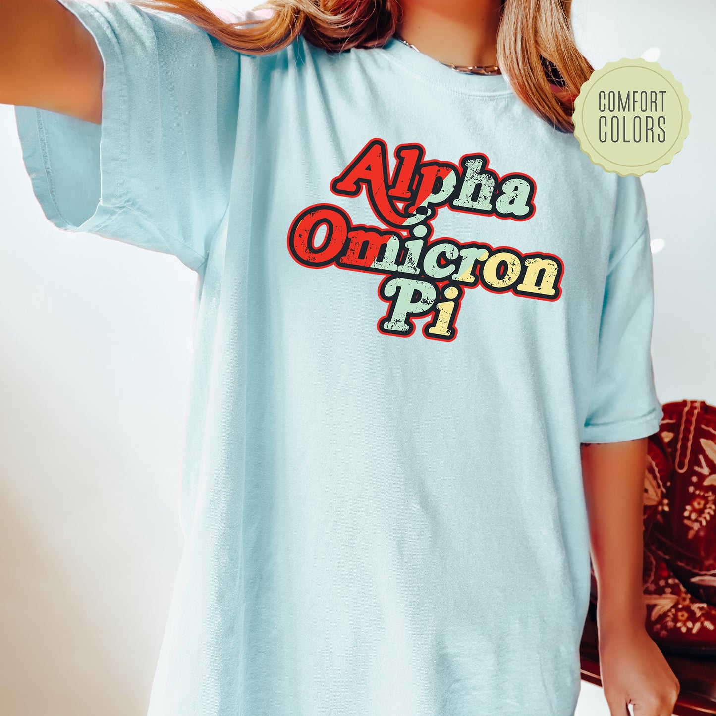 a woman wearing a light blue shirt with the words aloha and unicorn pi