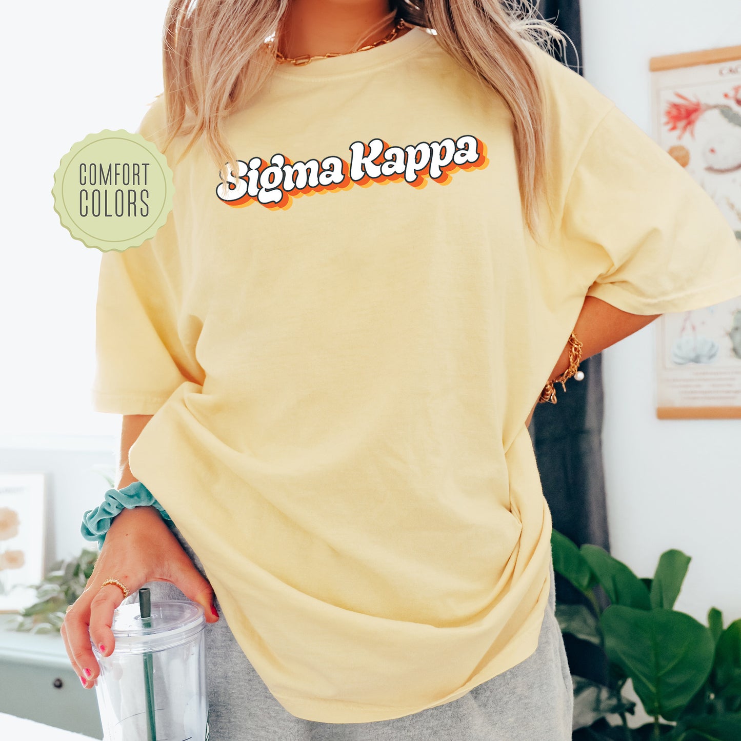 a woman in a yellow shirt holding a blender