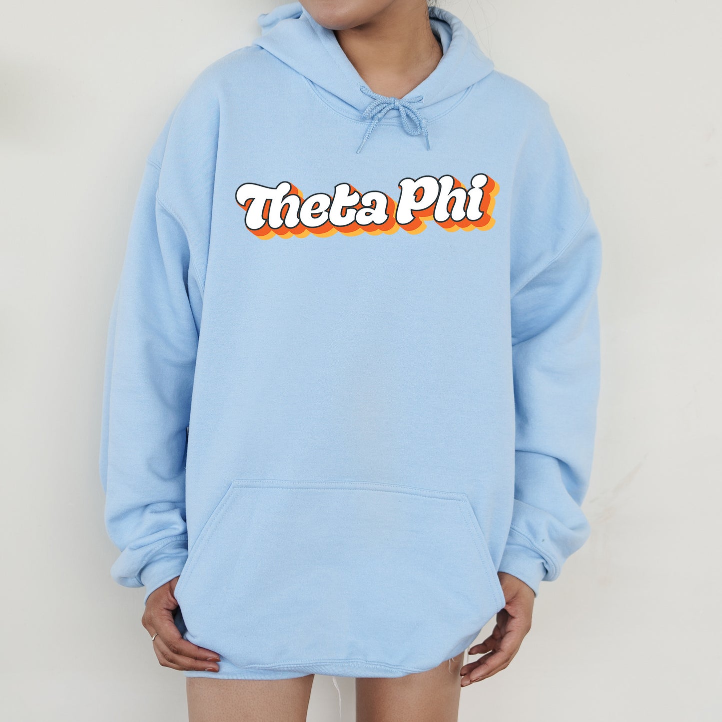 a person wearing a blue hoodie with the words thea pi on it