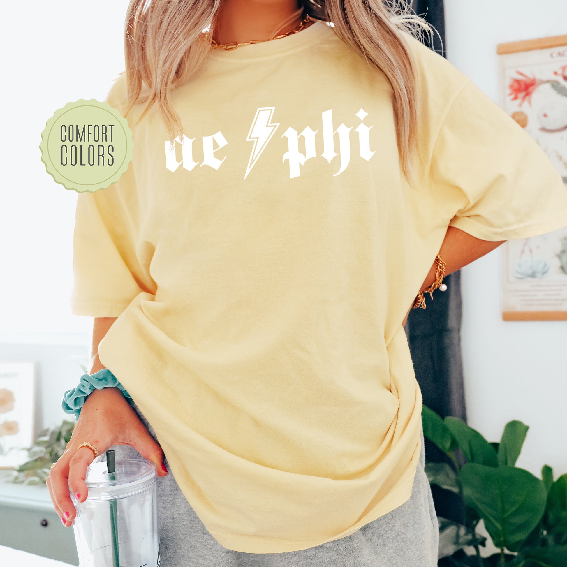 a woman in a yellow shirt holding a blender