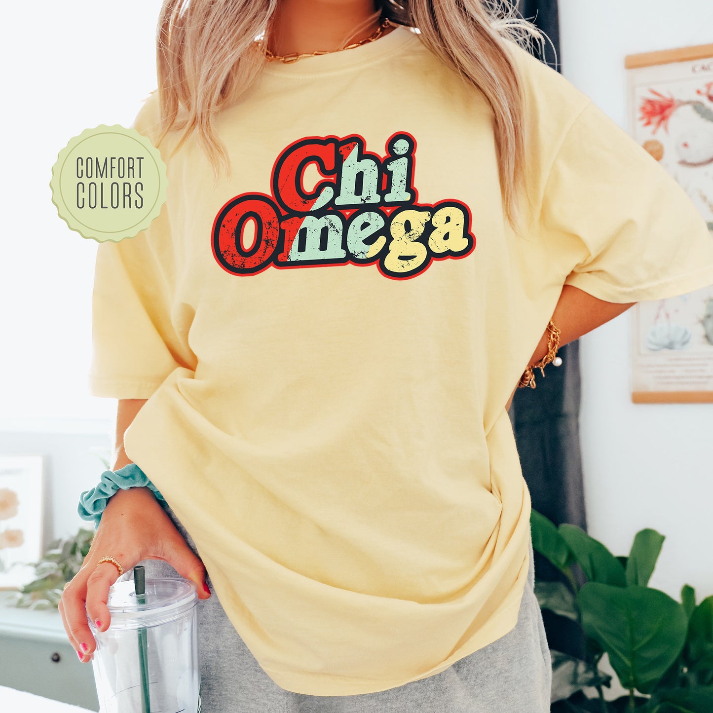 a woman in a yellow shirt holding a blender