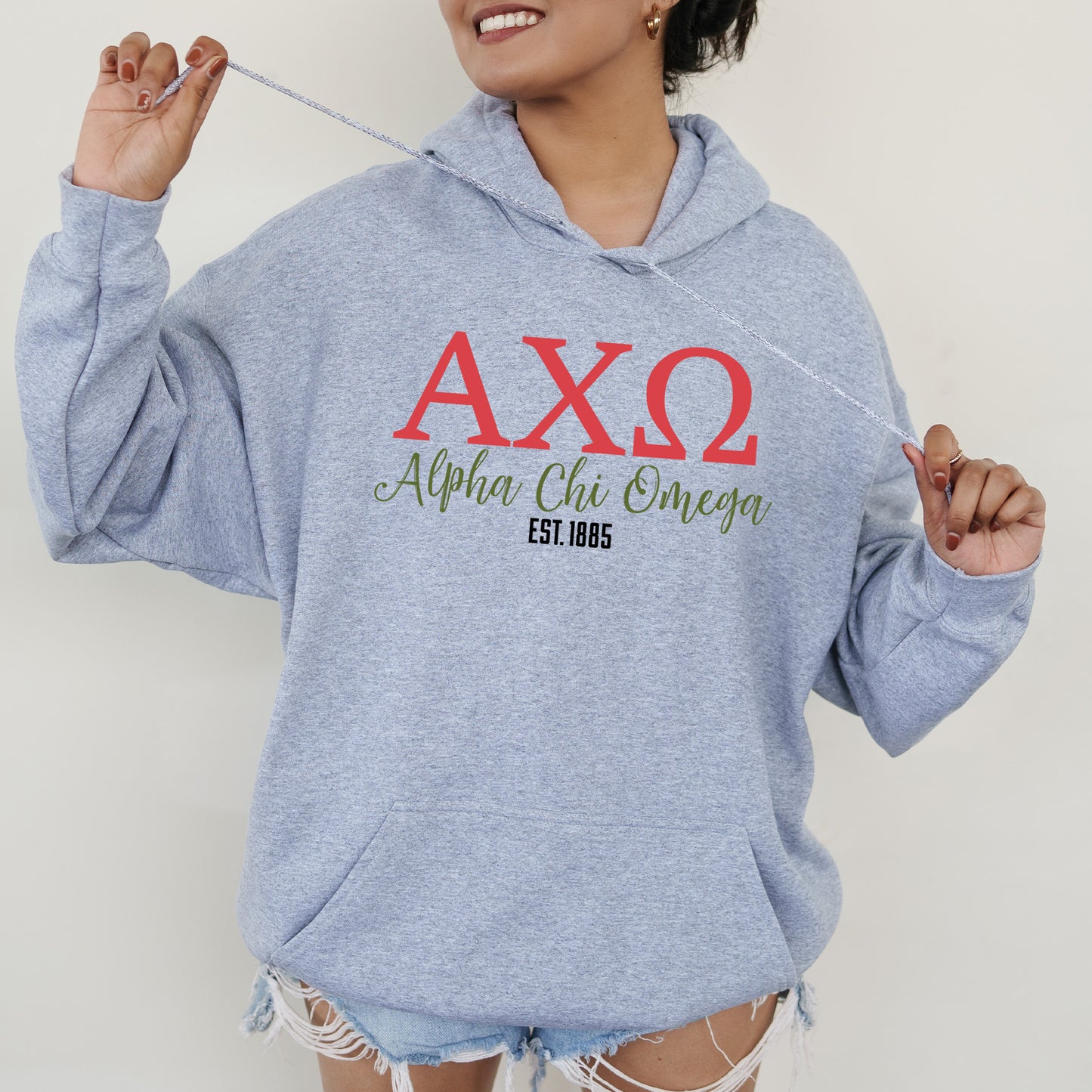 a woman in a blue hoodie is holding a string
