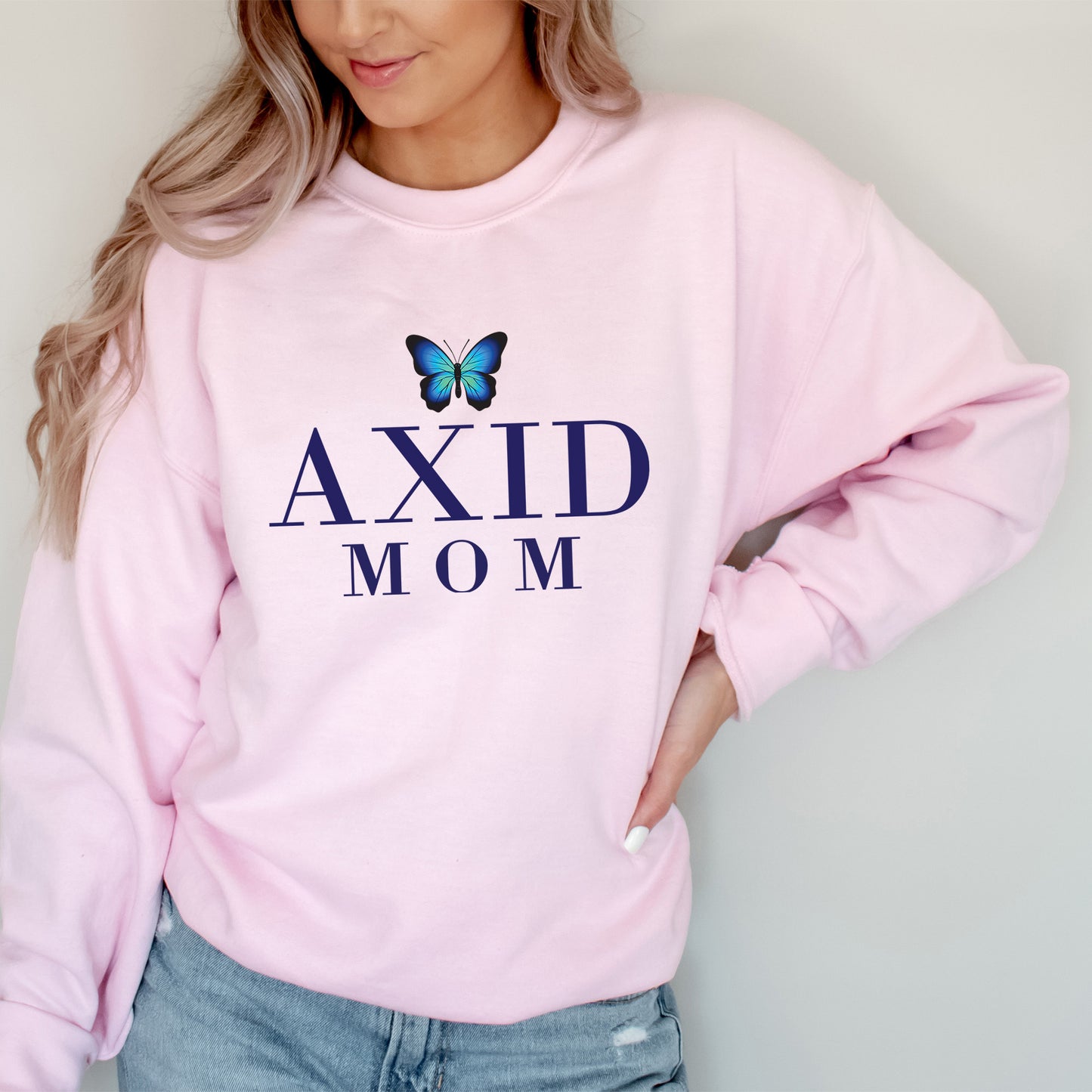 a woman wearing a pink sweatshirt with a butterfly on it