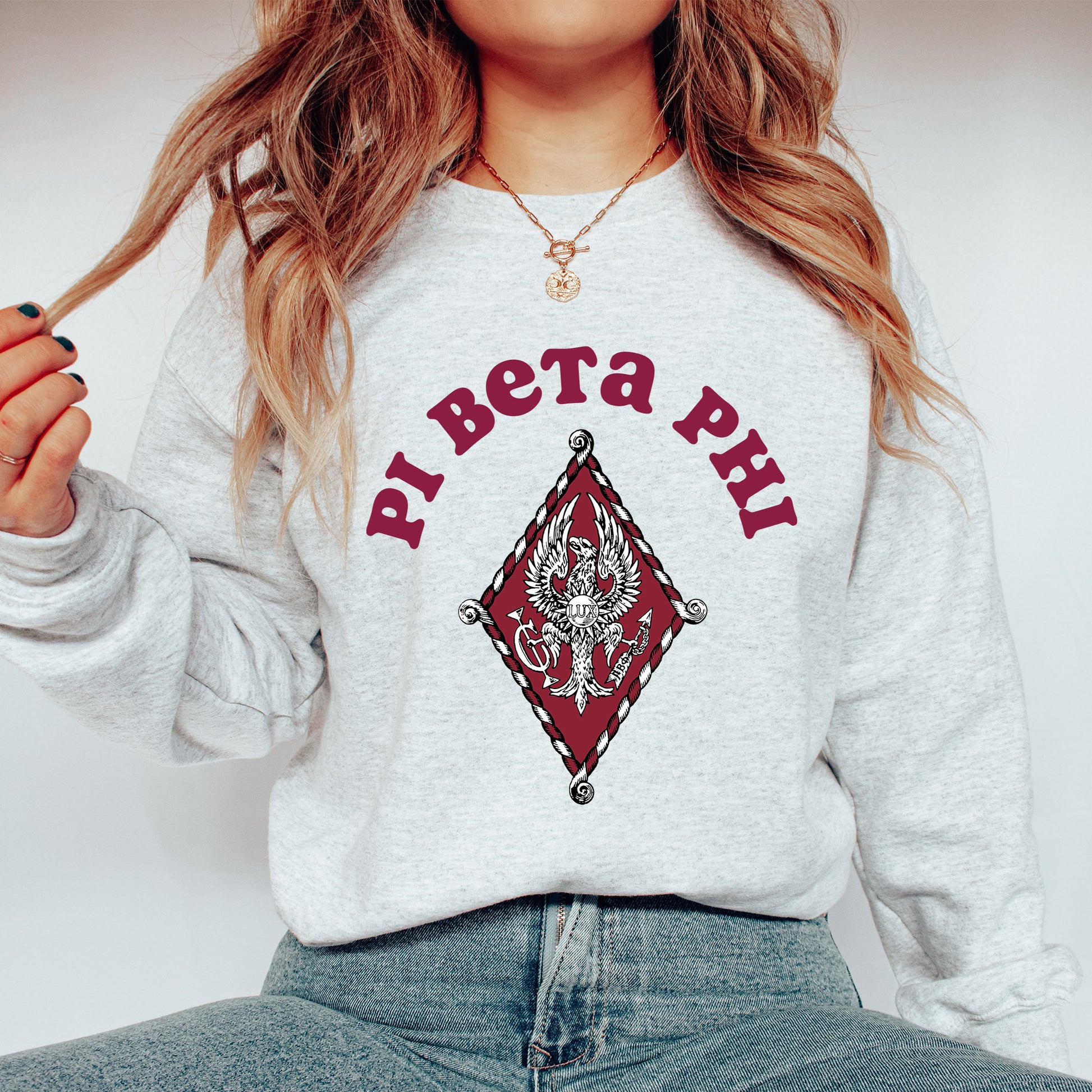 a woman with long hair wearing a sweatshirt and jeans