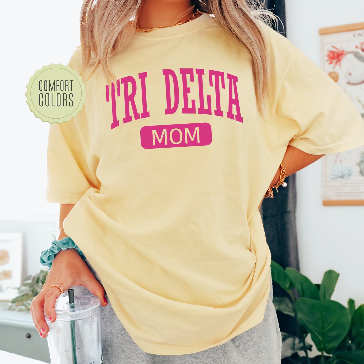 a woman in a yellow shirt holding a blender