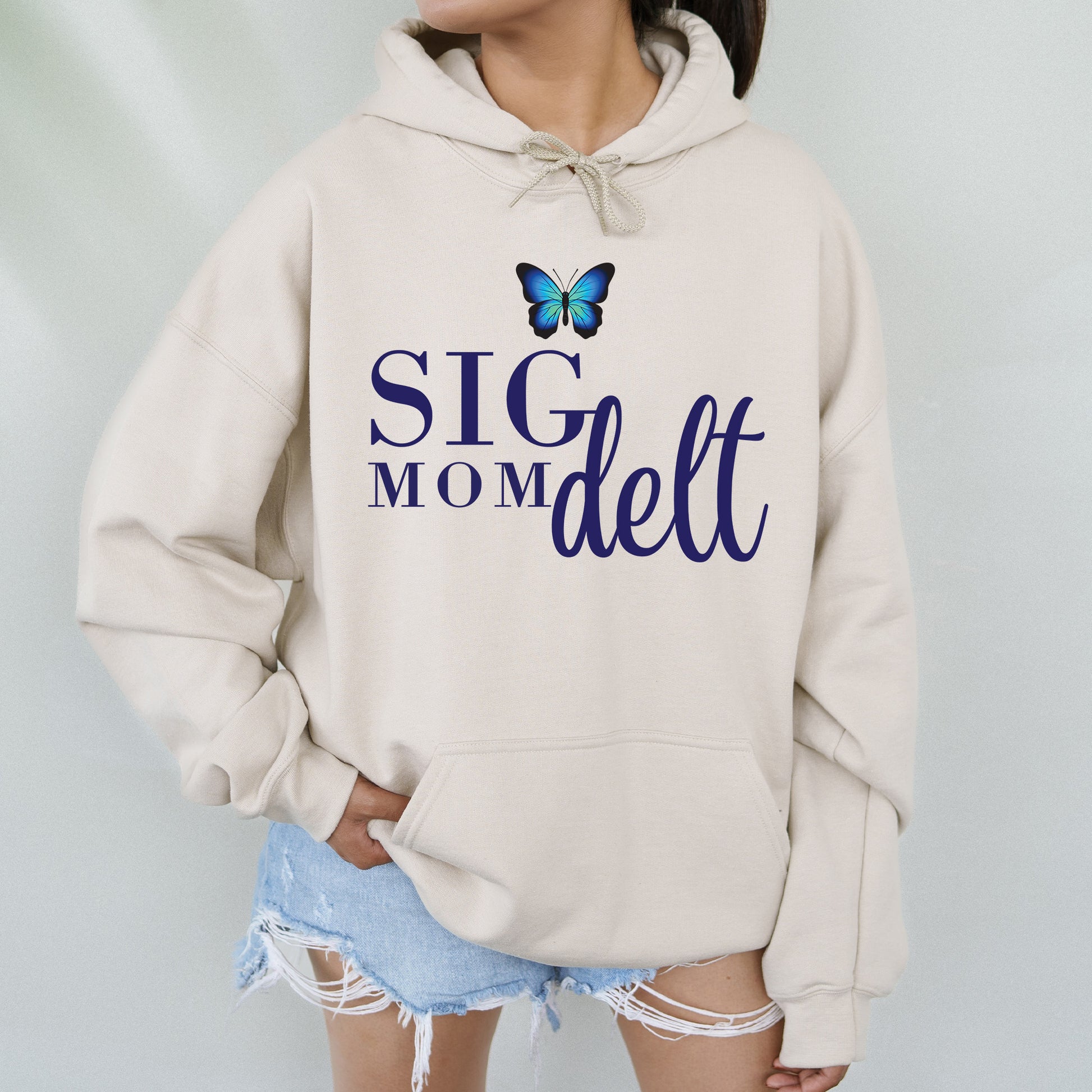 a woman wearing a sweatshirt with a butterfly on it