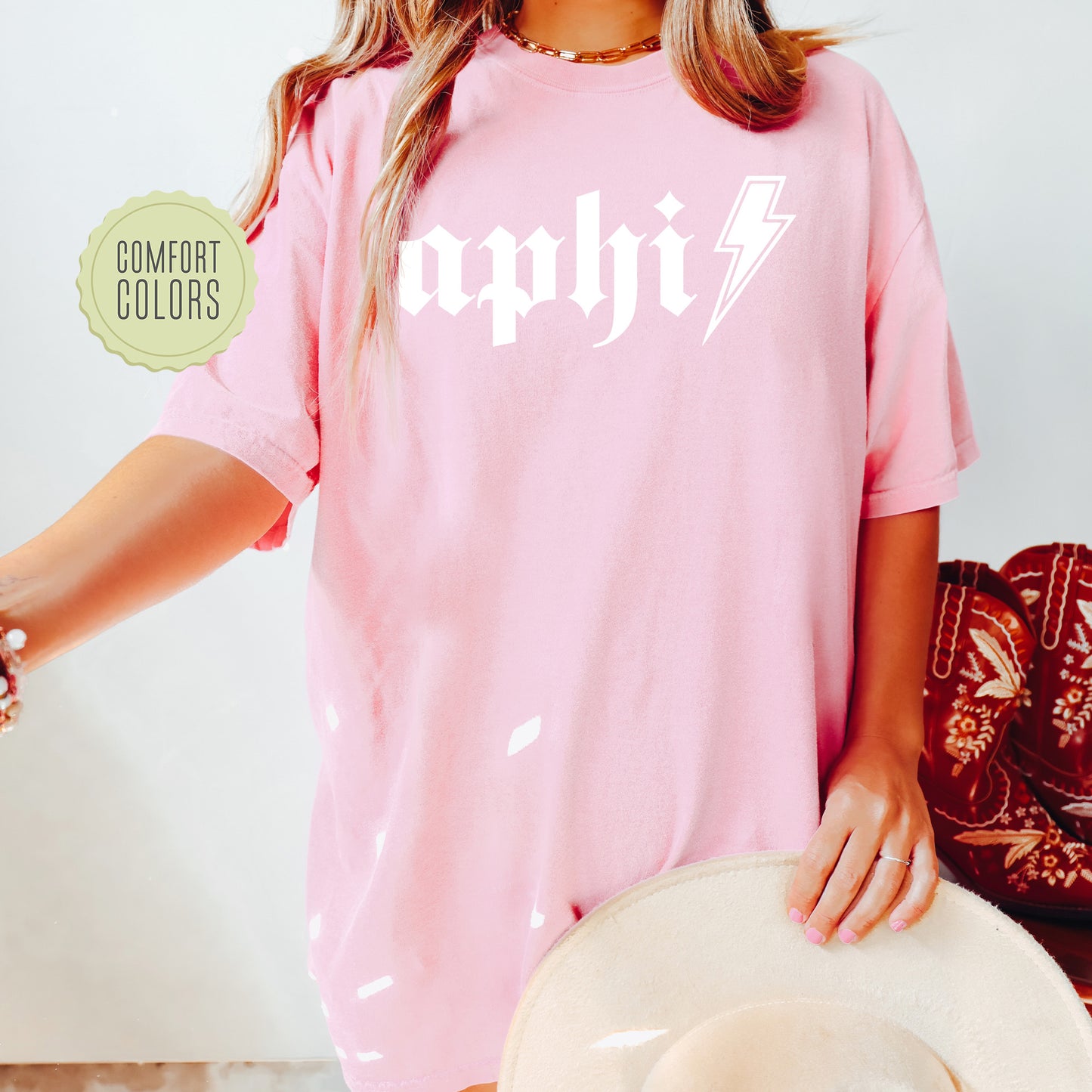 a woman wearing a pink shirt and hat