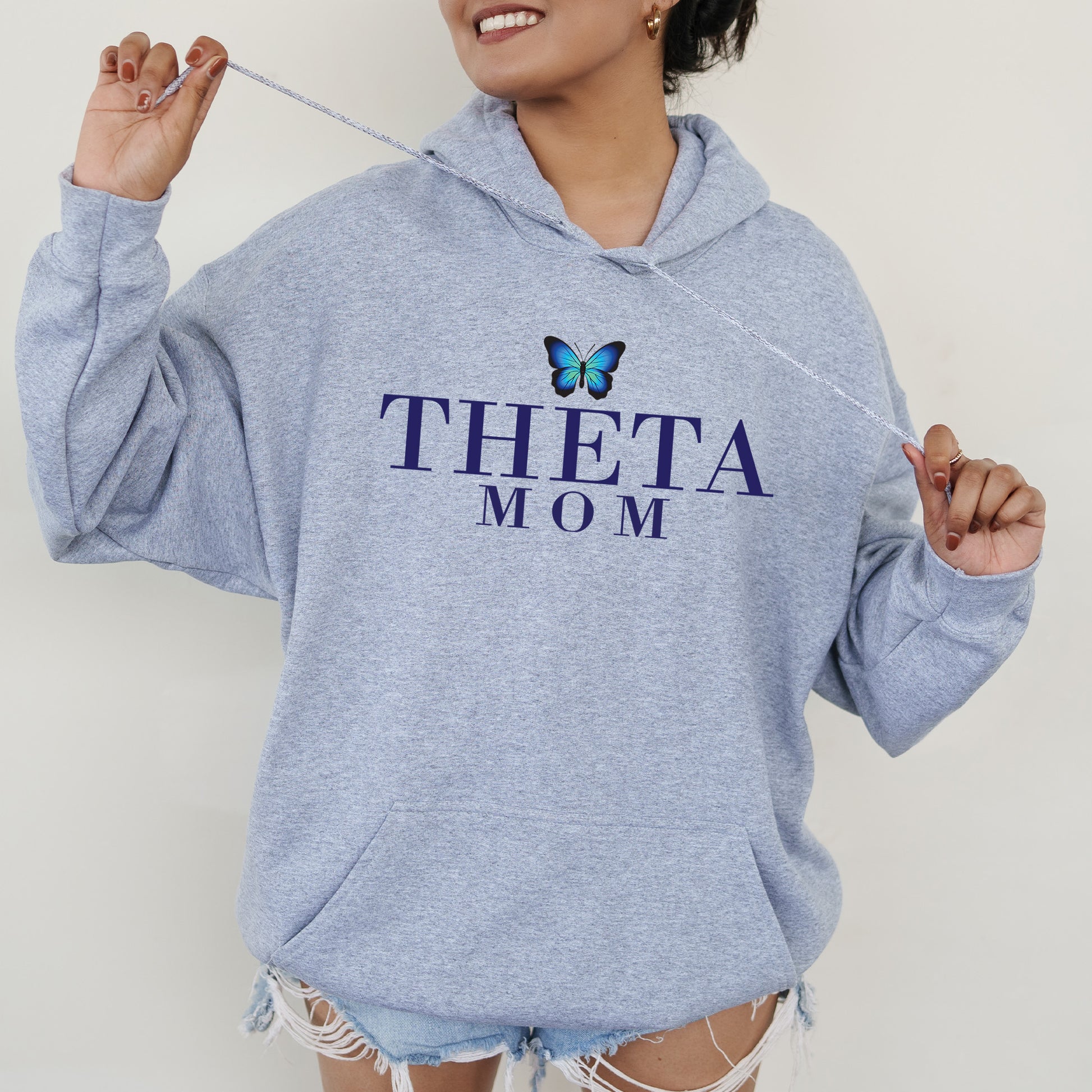 a woman wearing a sweatshirt with a butterfly on it