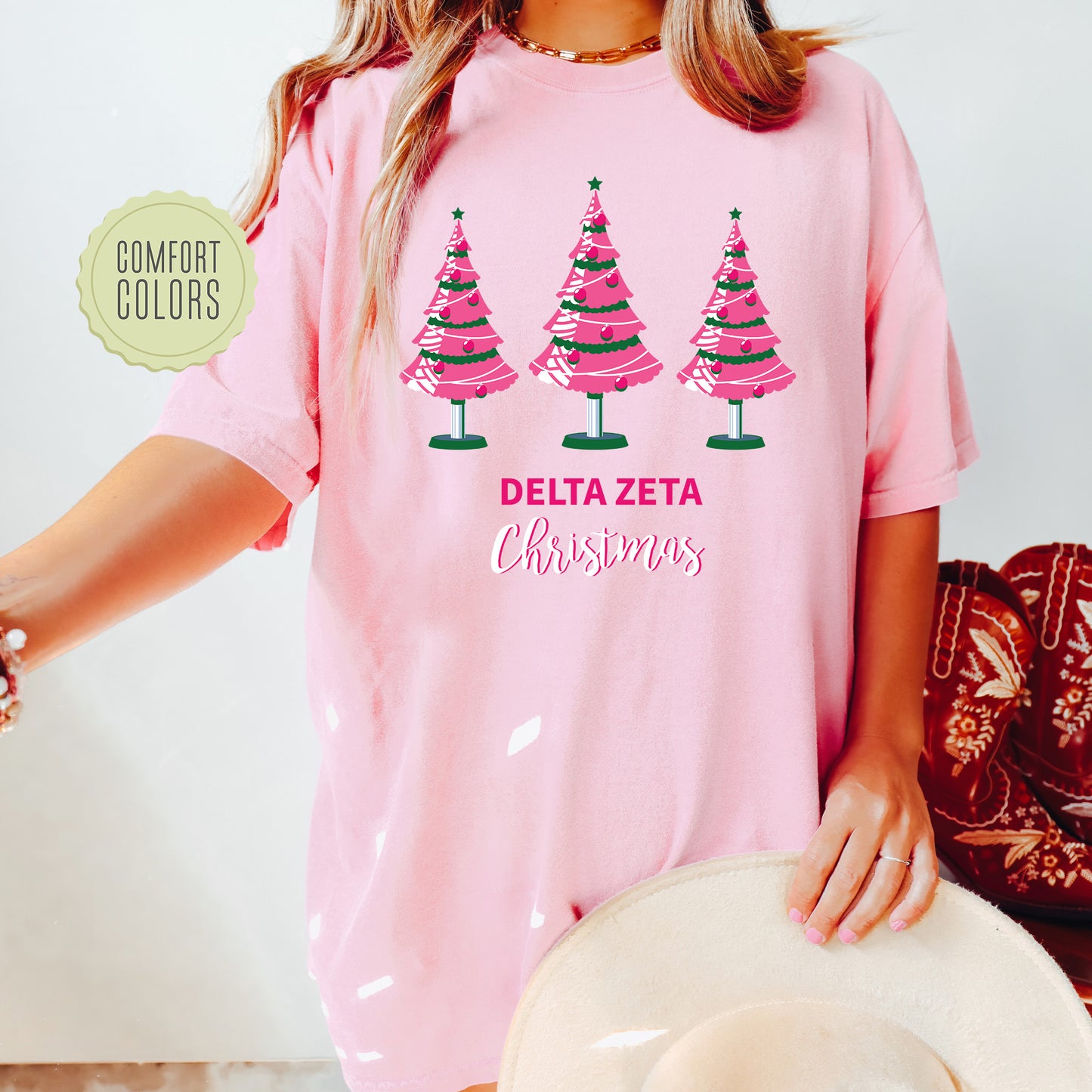 a woman wearing a pink shirt with christmas trees on it