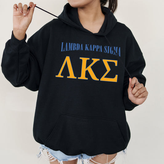 a woman wearing a black hoodie with the letters ake on it