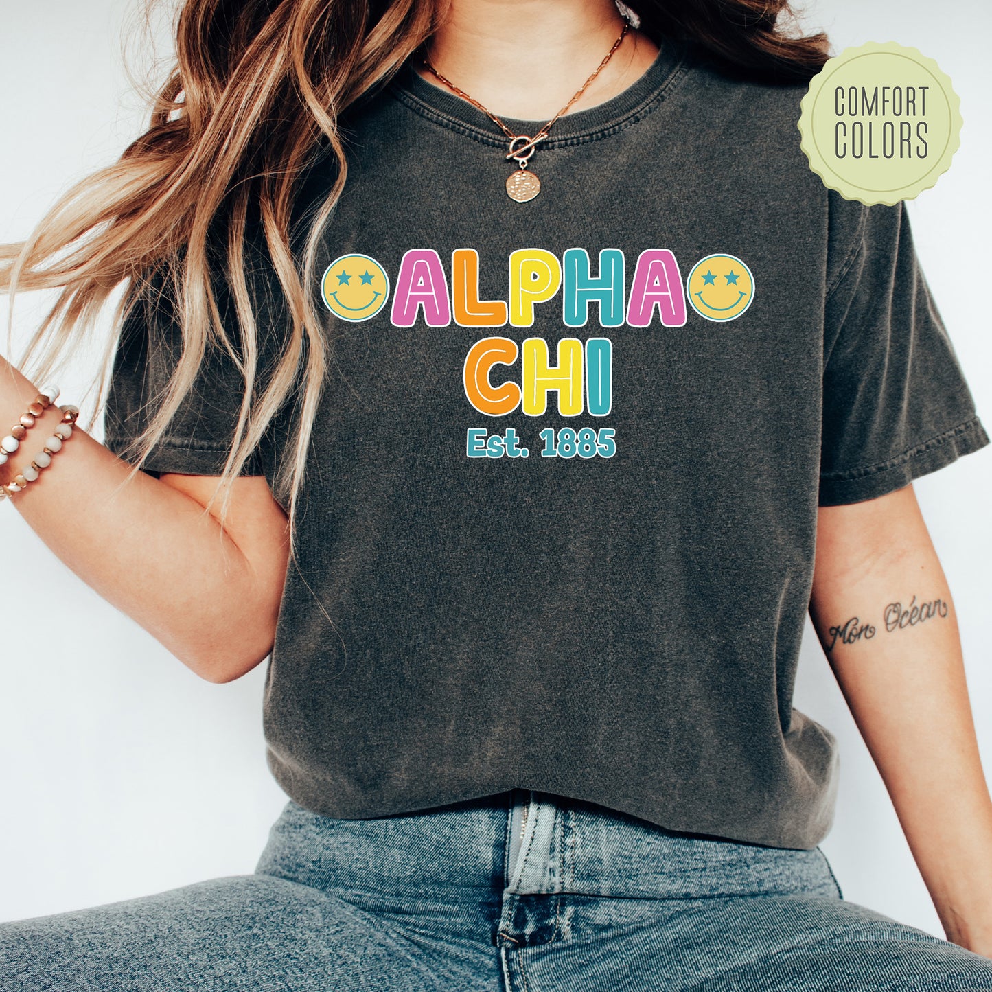 a woman wearing a black shirt with the word alpha chi on it