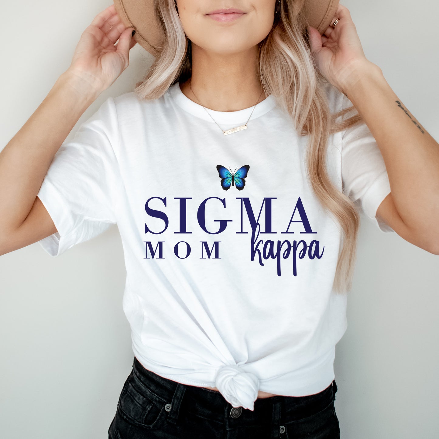 a woman wearing a white shirt with a butterfly on it