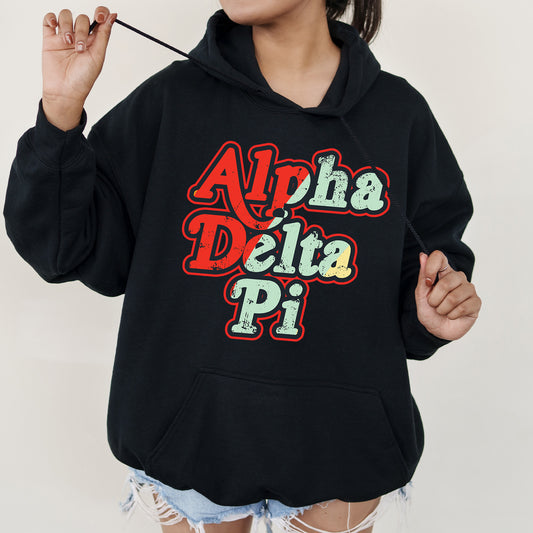 a woman wearing a black hoodie with the words aloha delta pi on