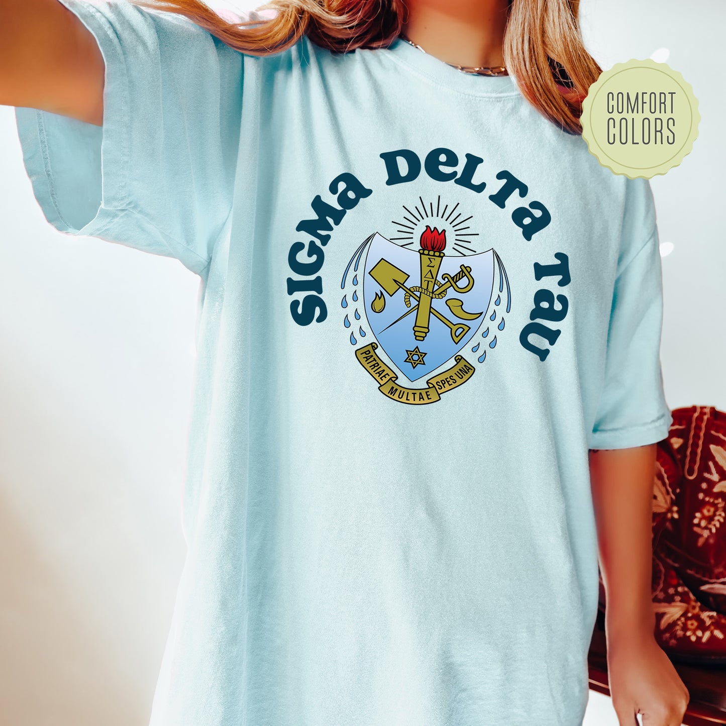 a young girl wearing a blue shirt with a crest on it