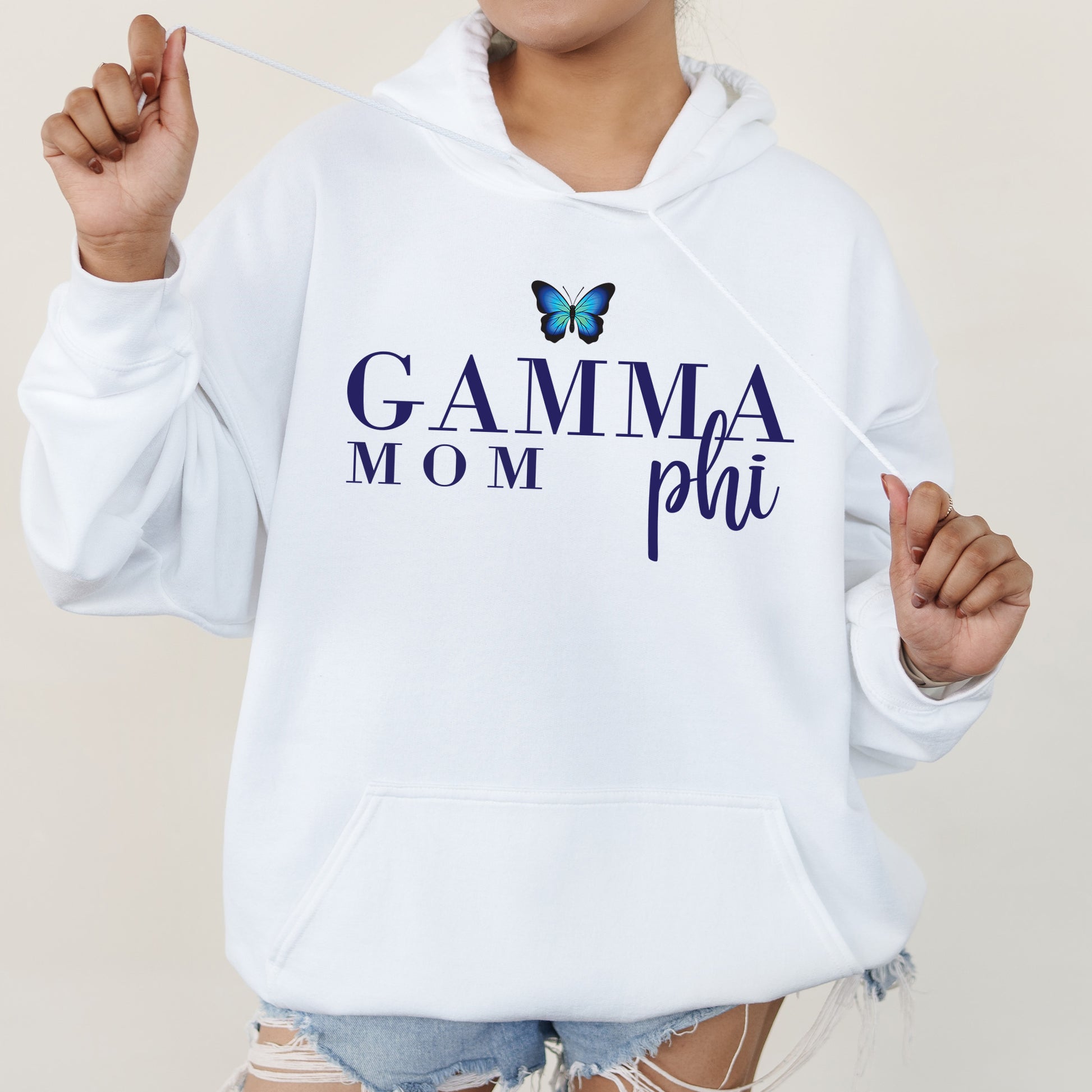 a woman wearing a white hoodie with a butterfly on it