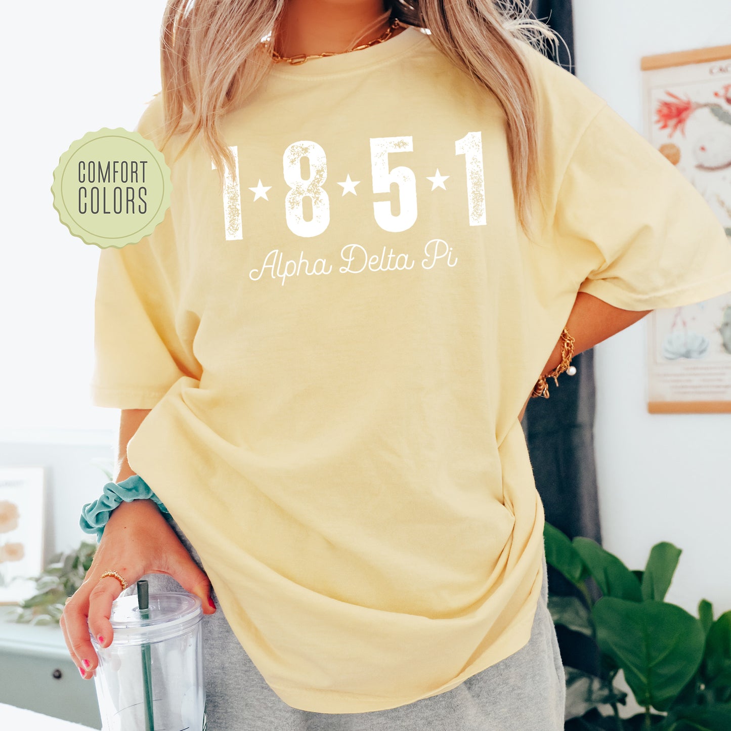 a woman in a yellow shirt holding a blender