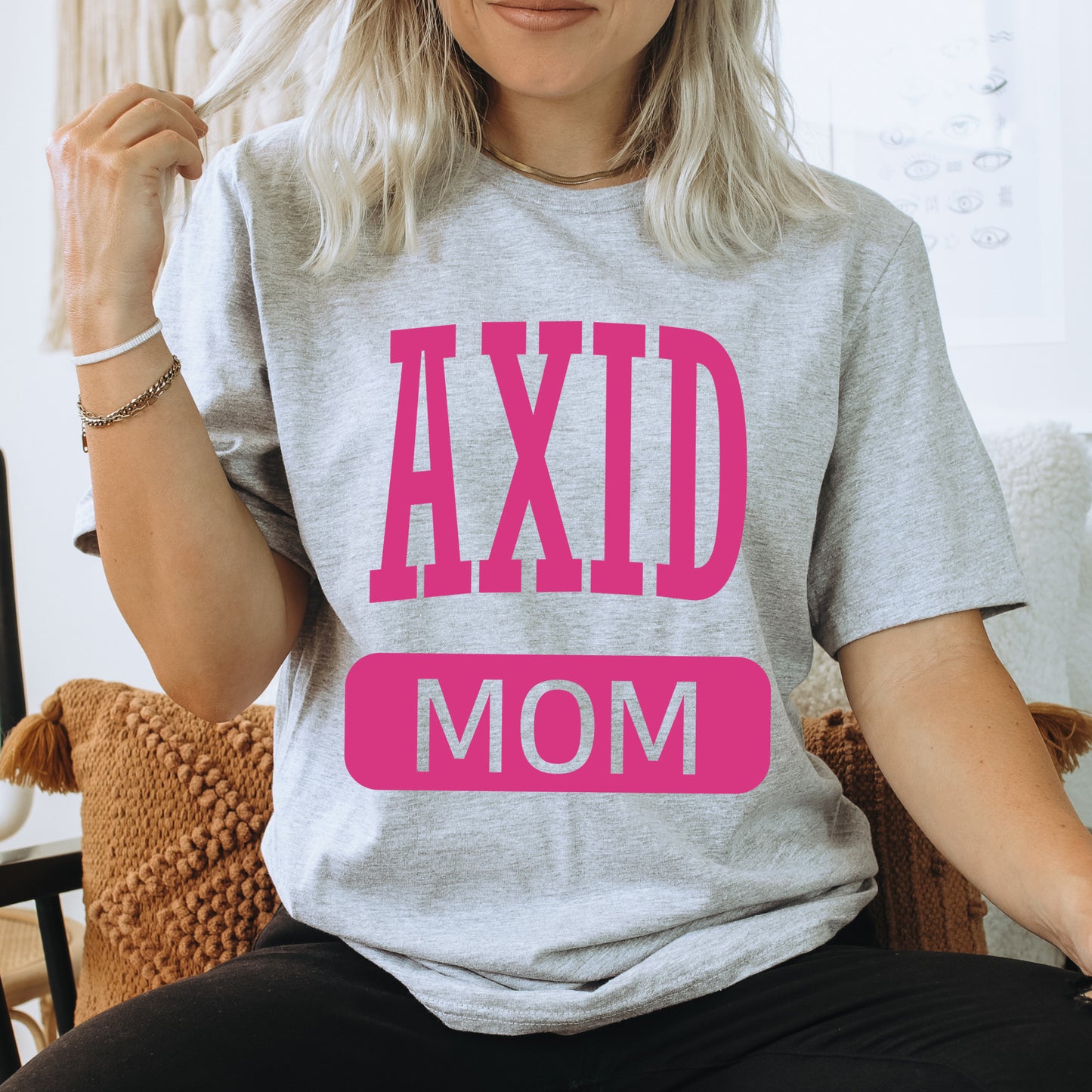 a woman wearing a t - shirt that says axd mom