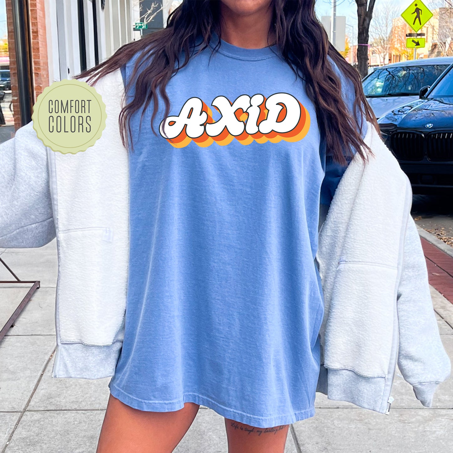 a woman wearing a blue shirt with the word acid on it