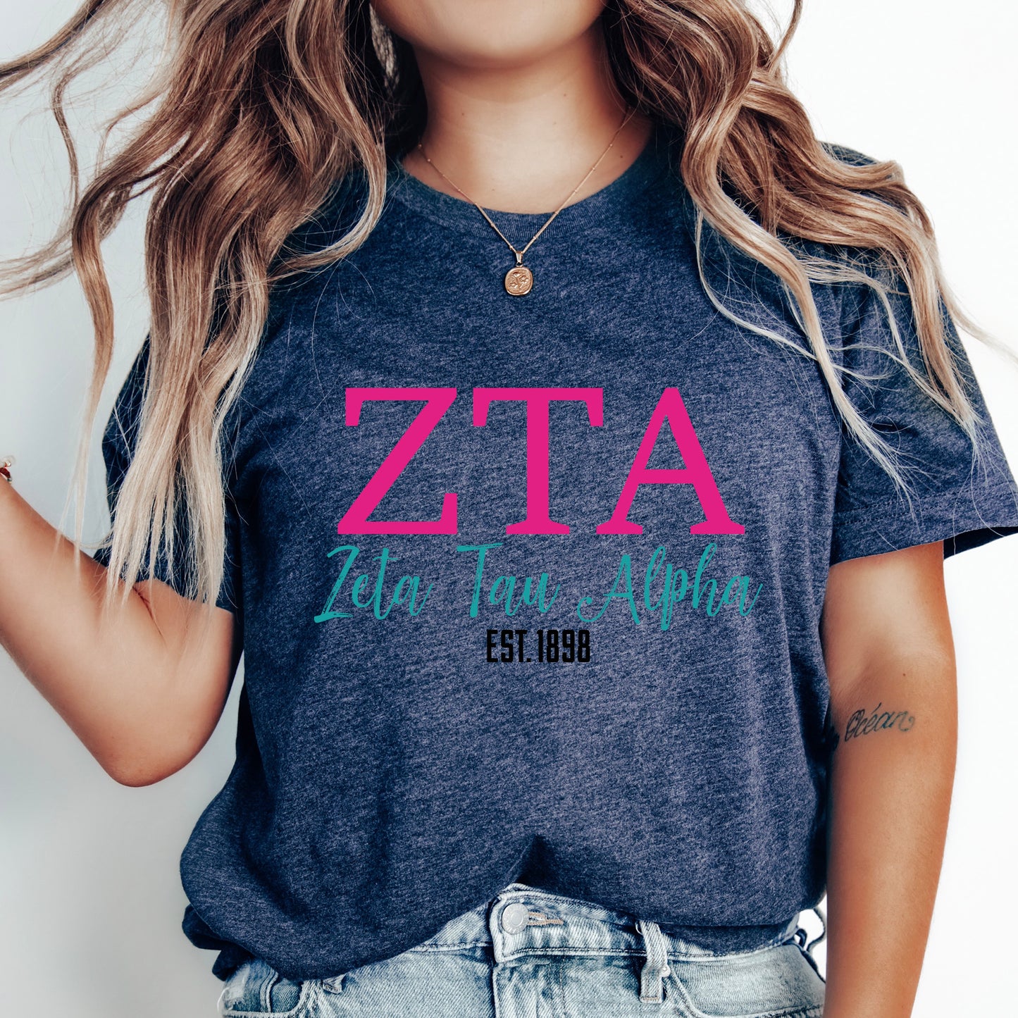 a woman with long hair wearing a t - shirt that says zta