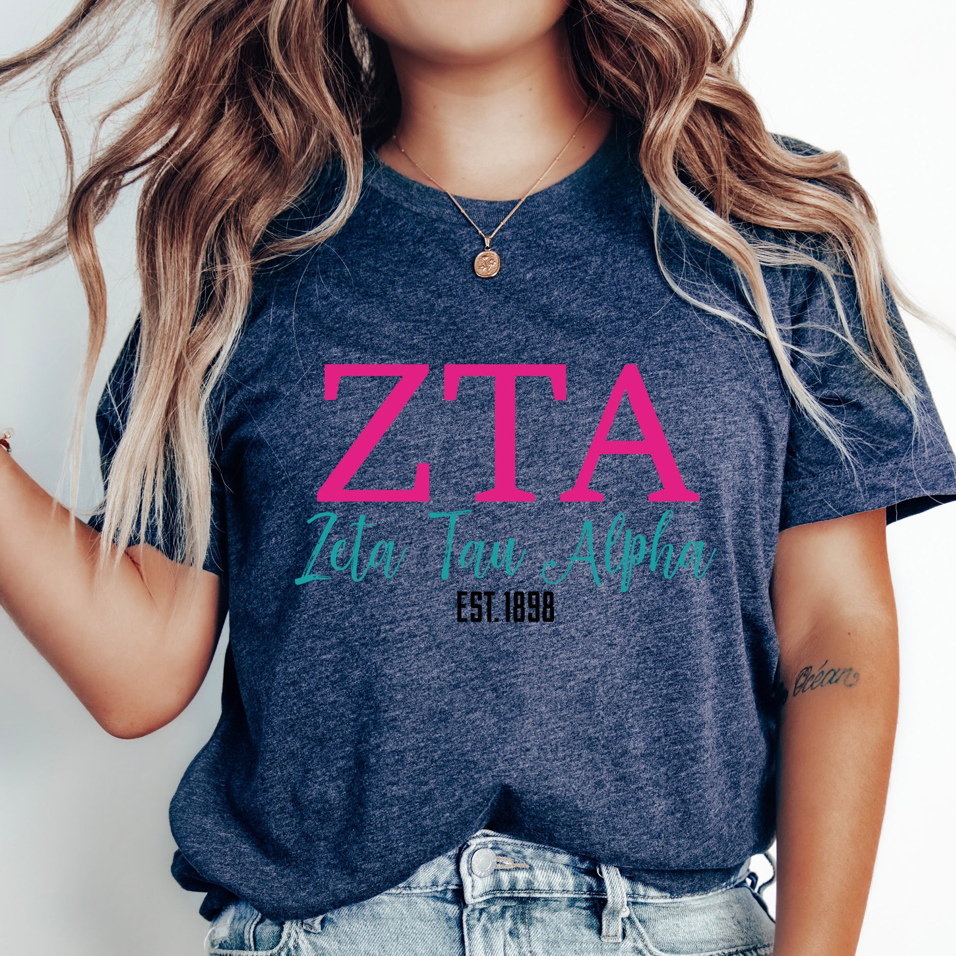 a woman with long hair wearing a t - shirt that says zta