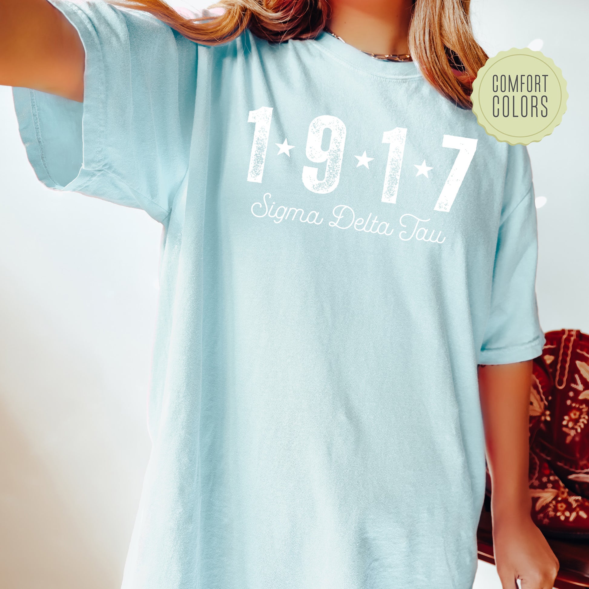 a woman wearing a light blue shirt with the number 1917 printed on it