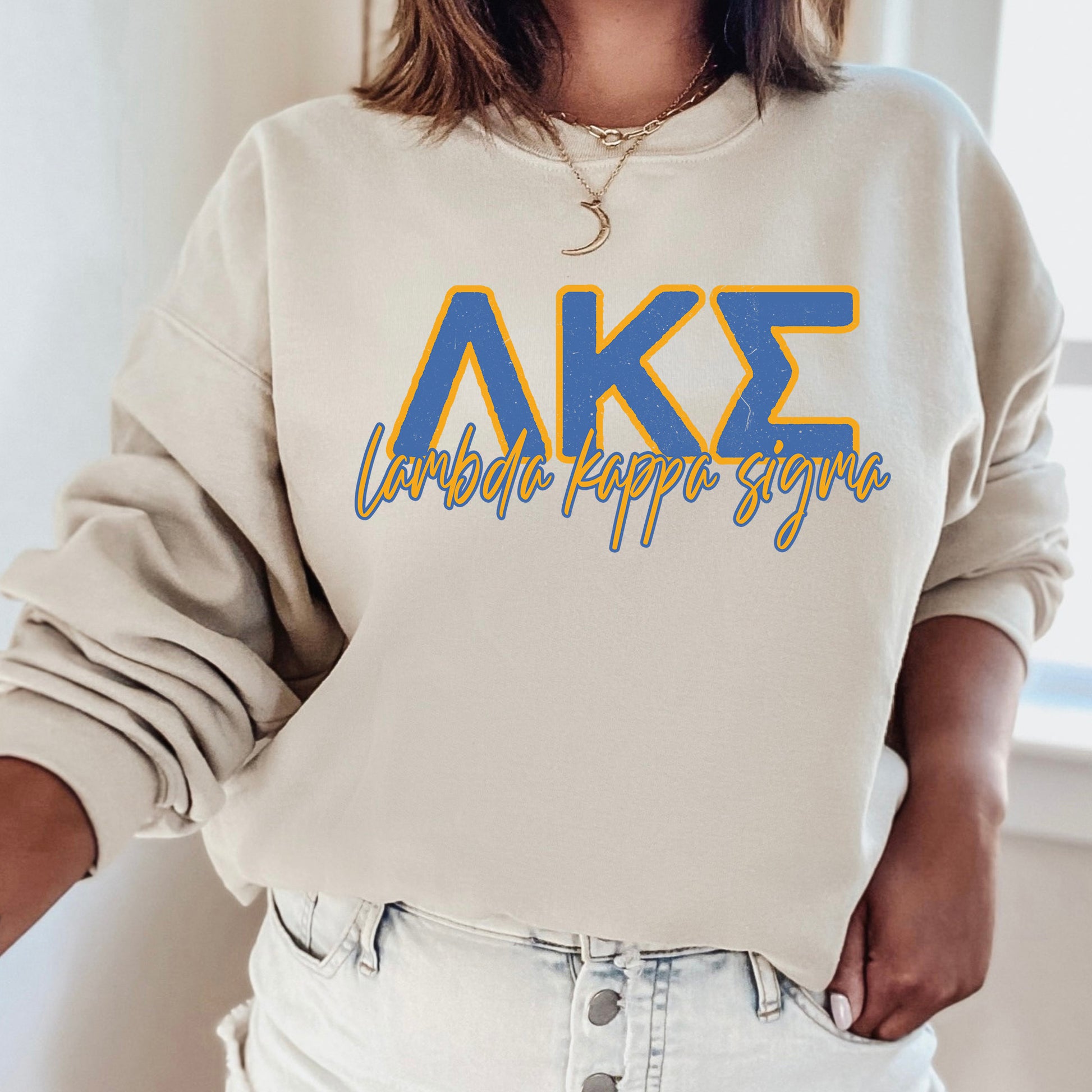 a woman wearing a white sweatshirt with the letters ake on it