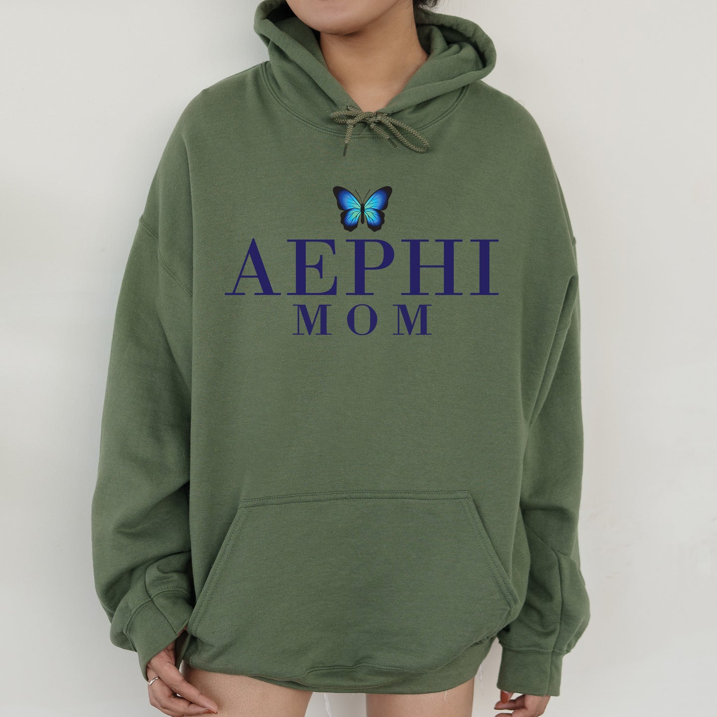 a woman wearing a green hoodie with a butterfly on it
