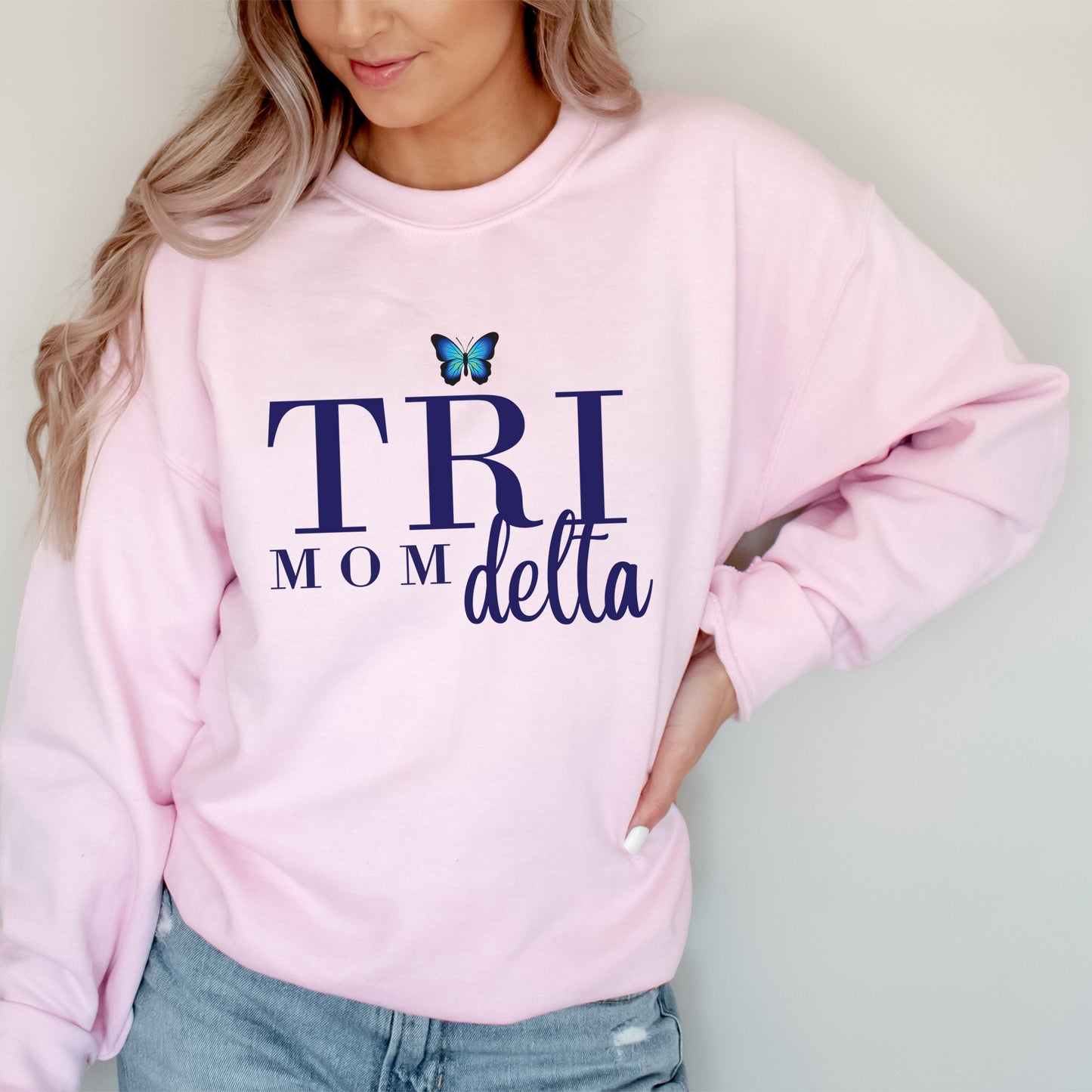 a woman wearing a pink sweatshirt with a butterfly on it