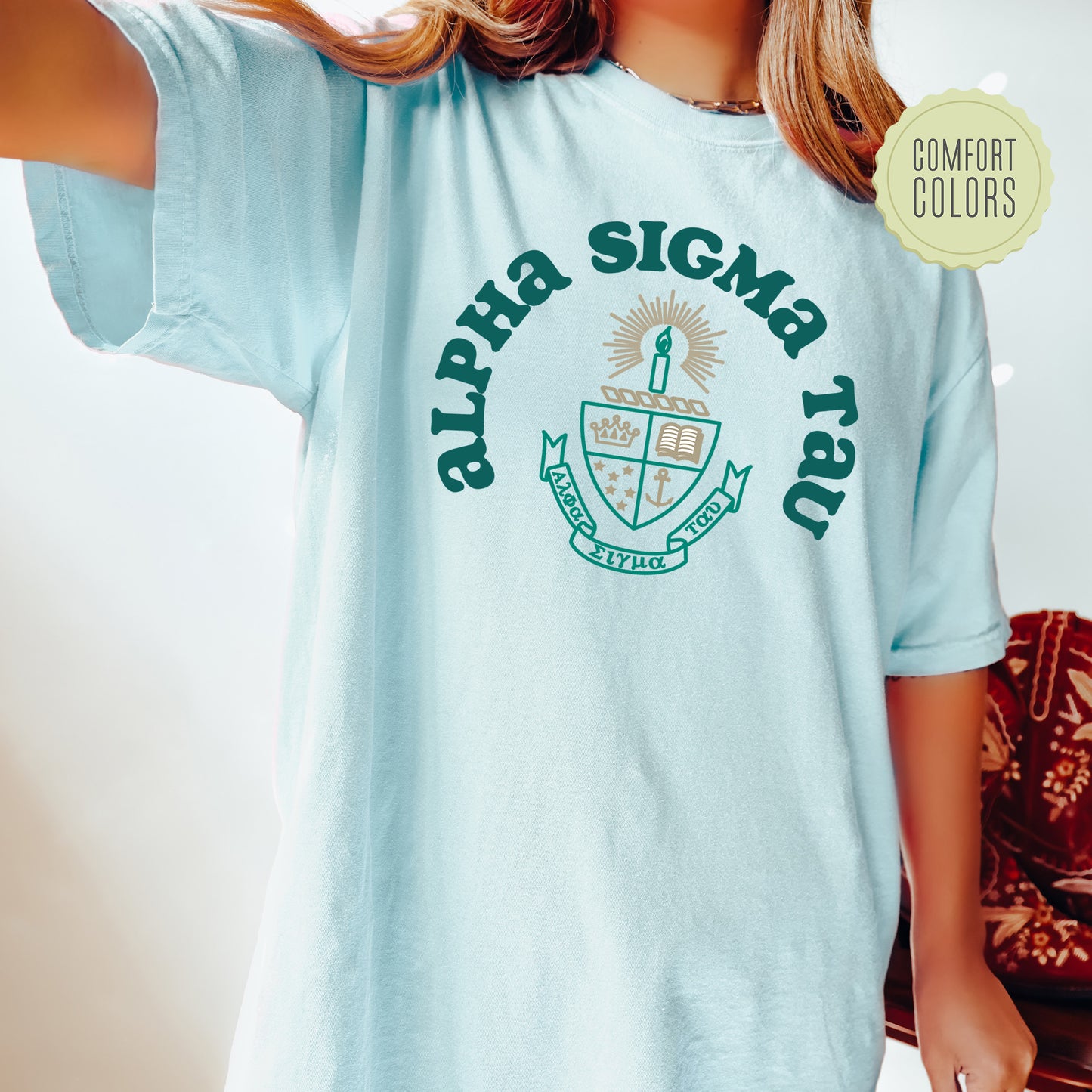 a young girl wearing a blue shirt with a green logo on it