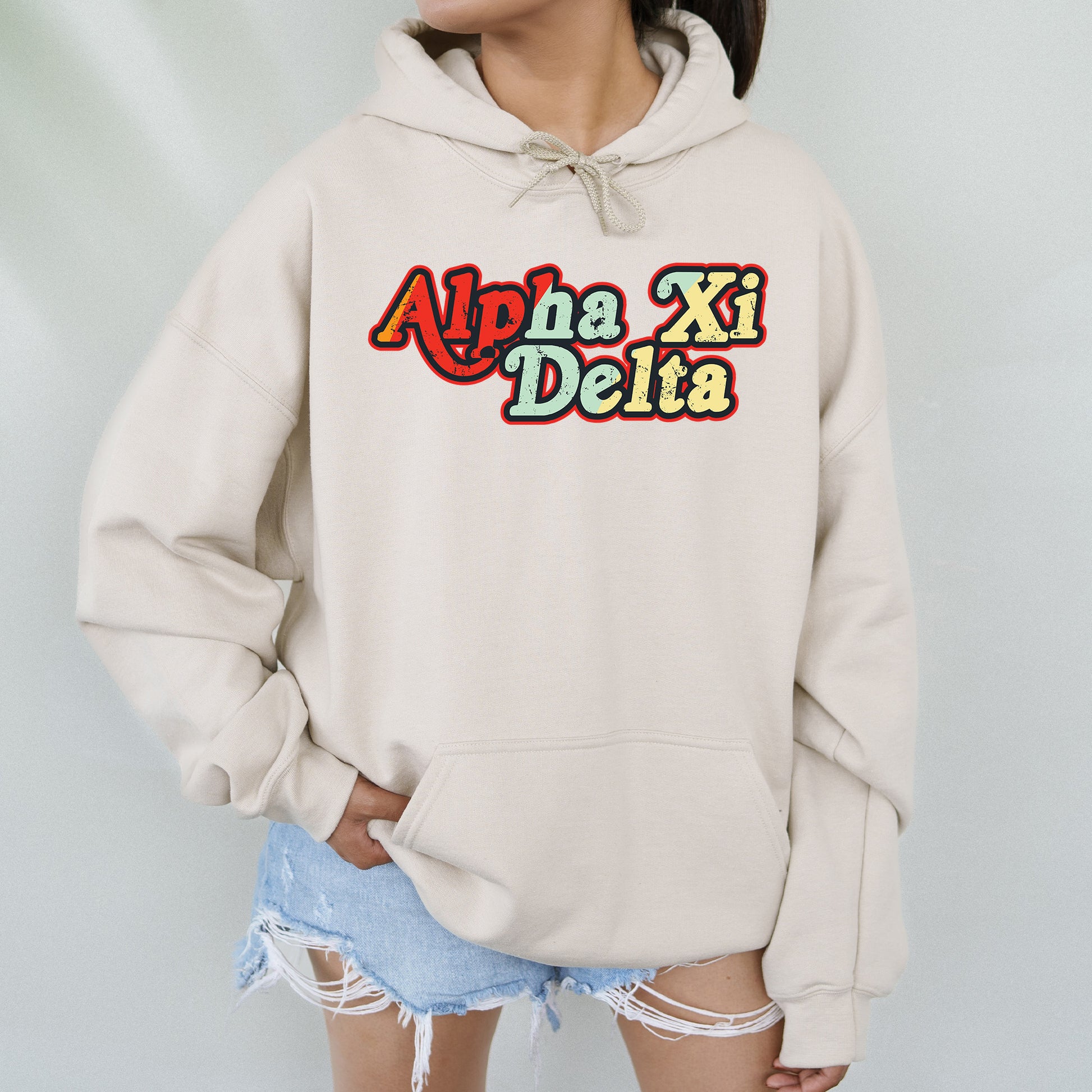 a woman wearing a white hoodie with the words apex xi delta on it