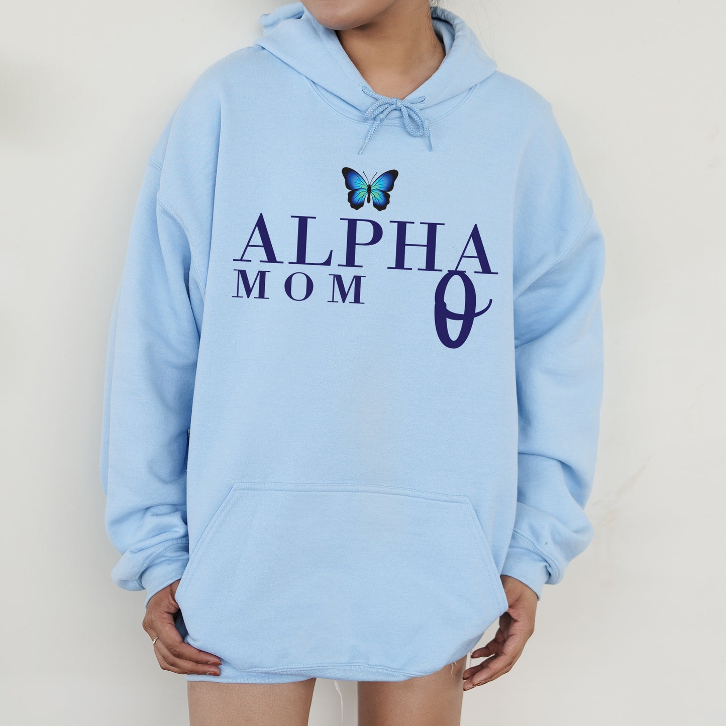 a woman wearing a blue hoodie with a butterfly on it