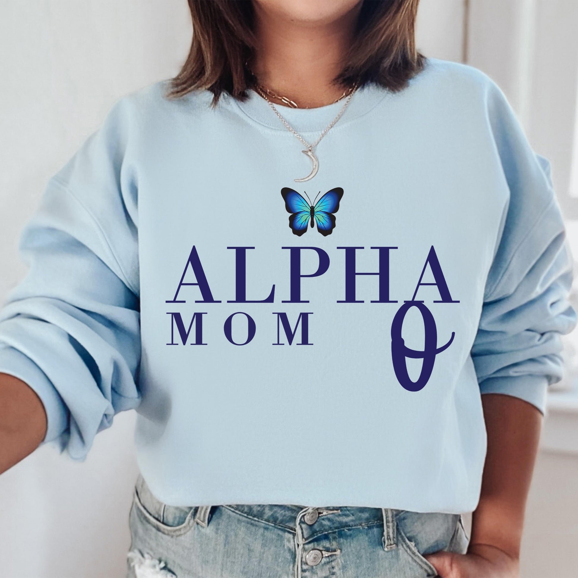 a woman wearing a blue sweatshirt with a butterfly on it