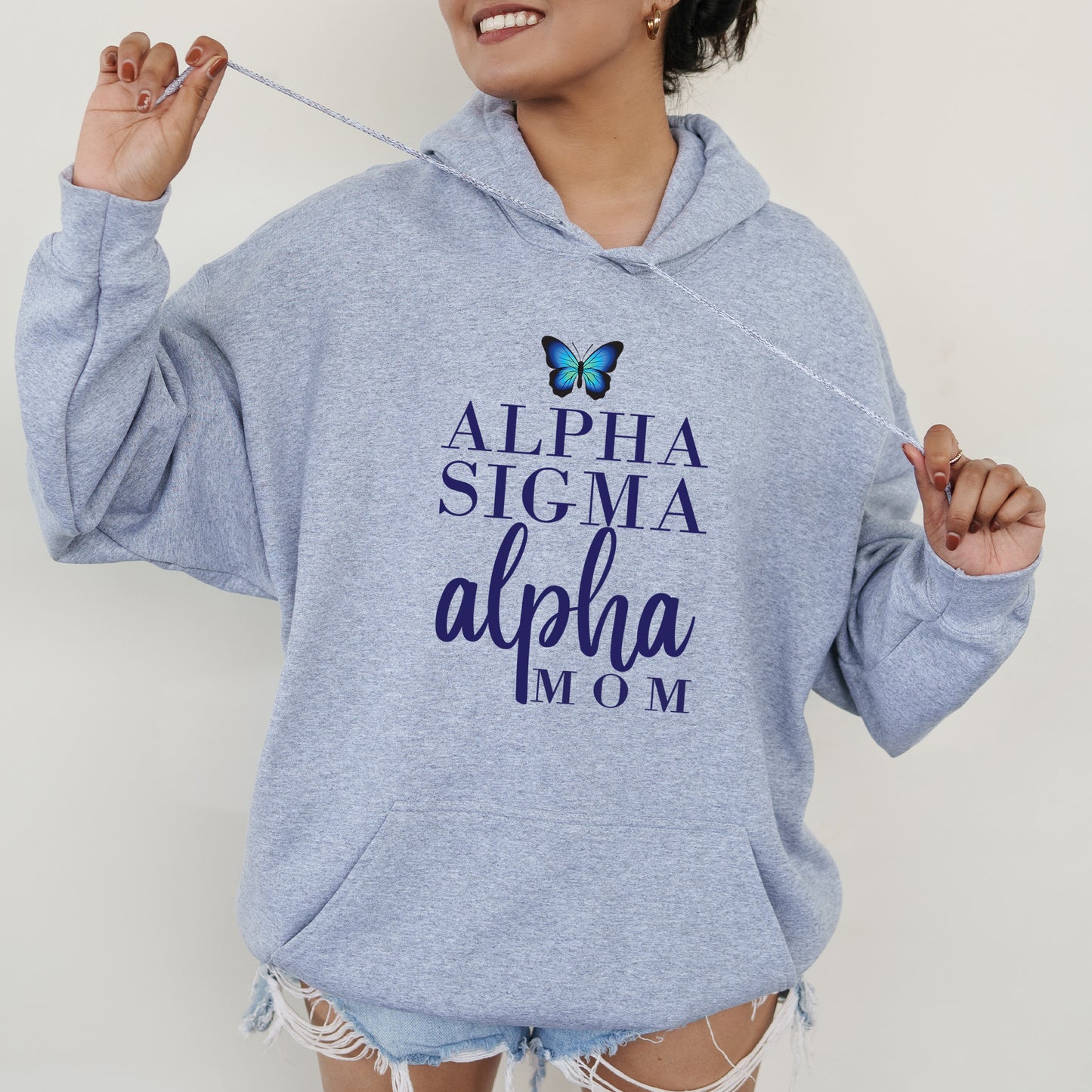 a woman wearing a blue sweatshirt with a butterfly on it