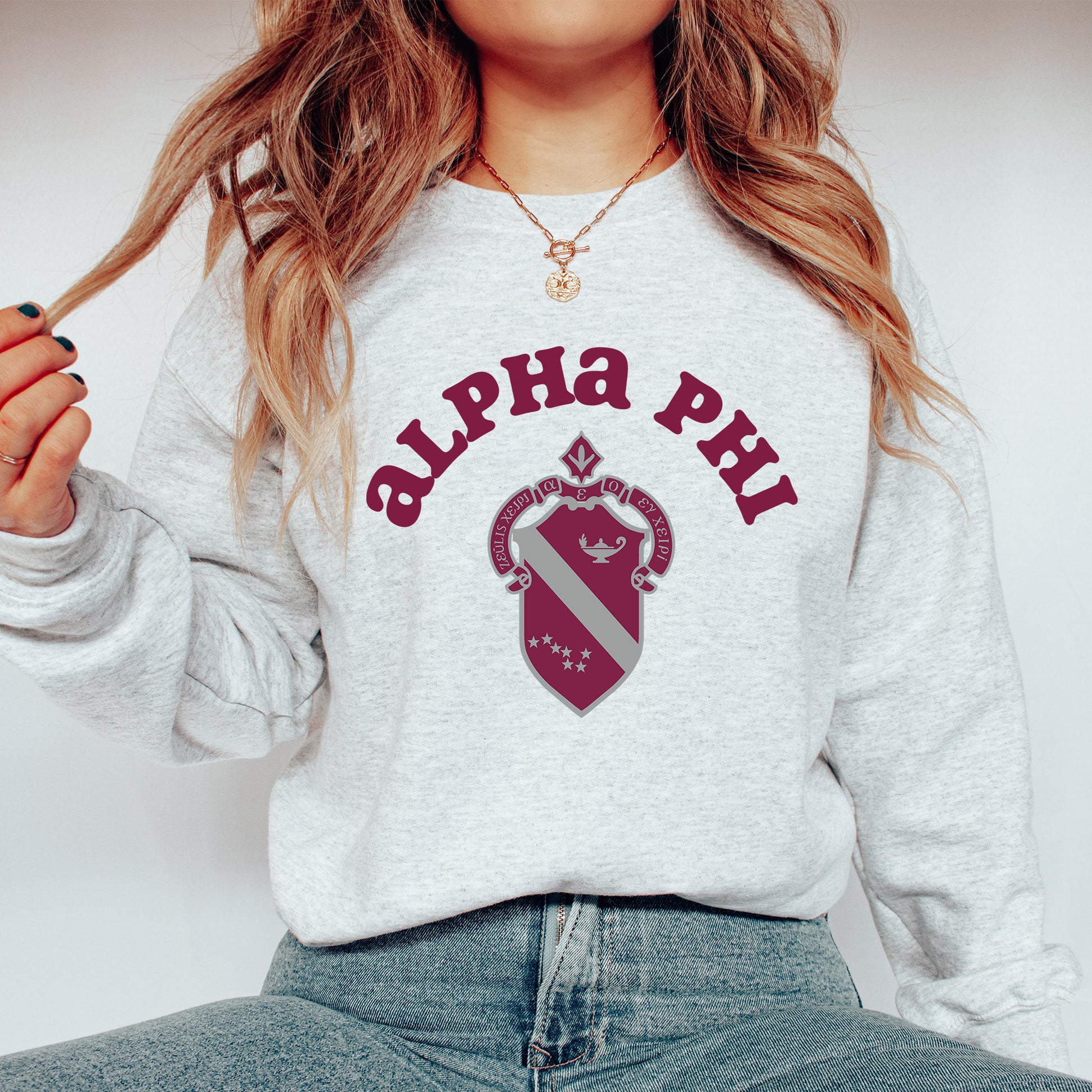 a woman wearing a sweatshirt with the letters phi phi on it