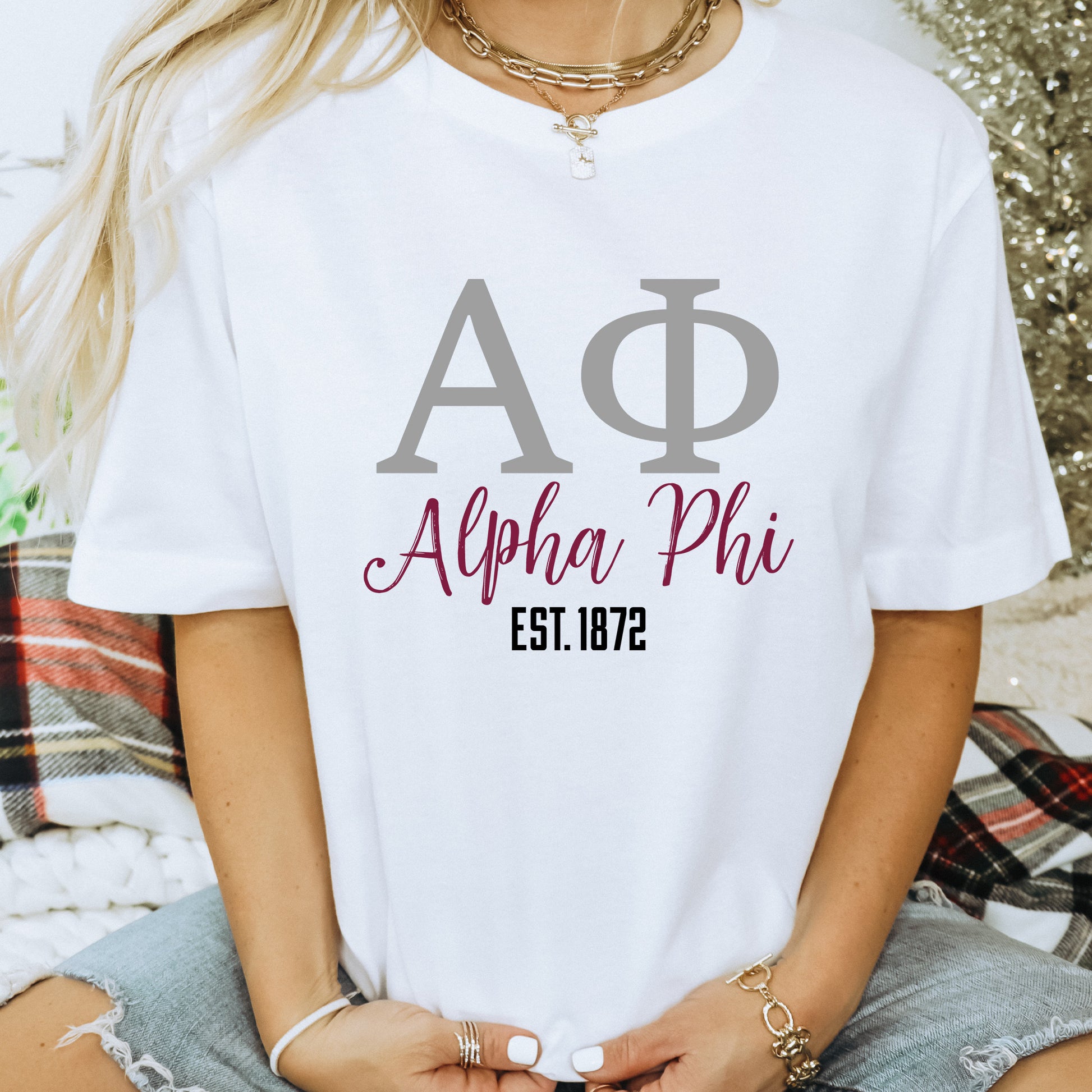 a woman wearing a white shirt with a phi phi on it