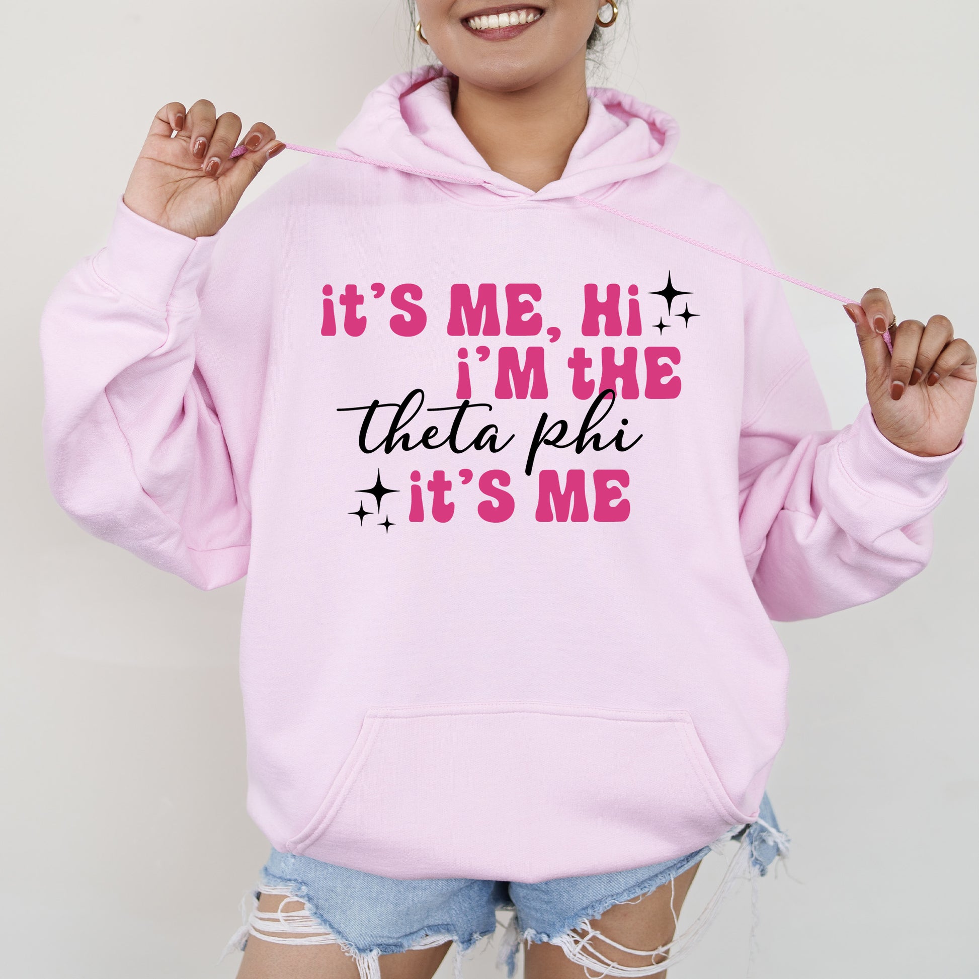 a woman wearing a pink hoodie that says it's me, i '