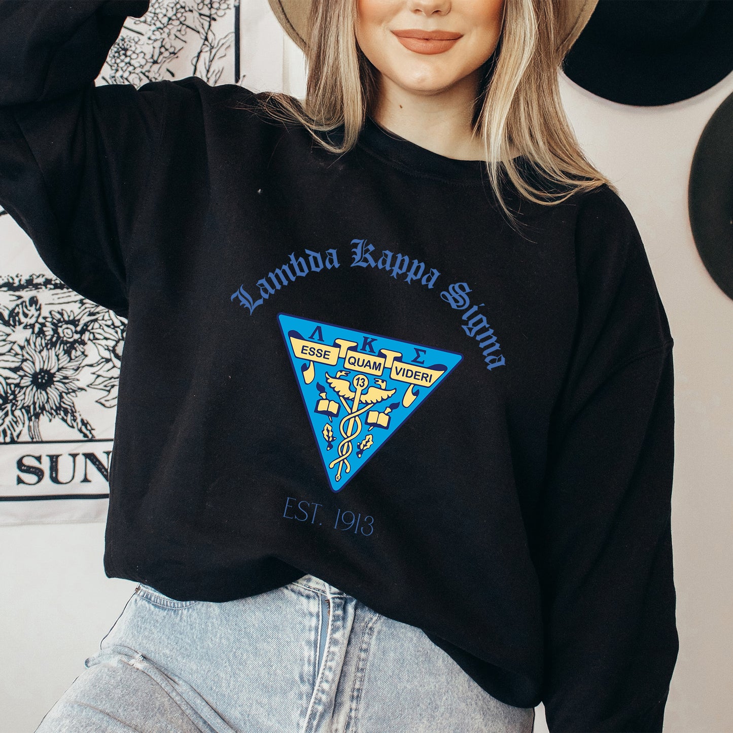a woman wearing a hat and a black sweatshirt