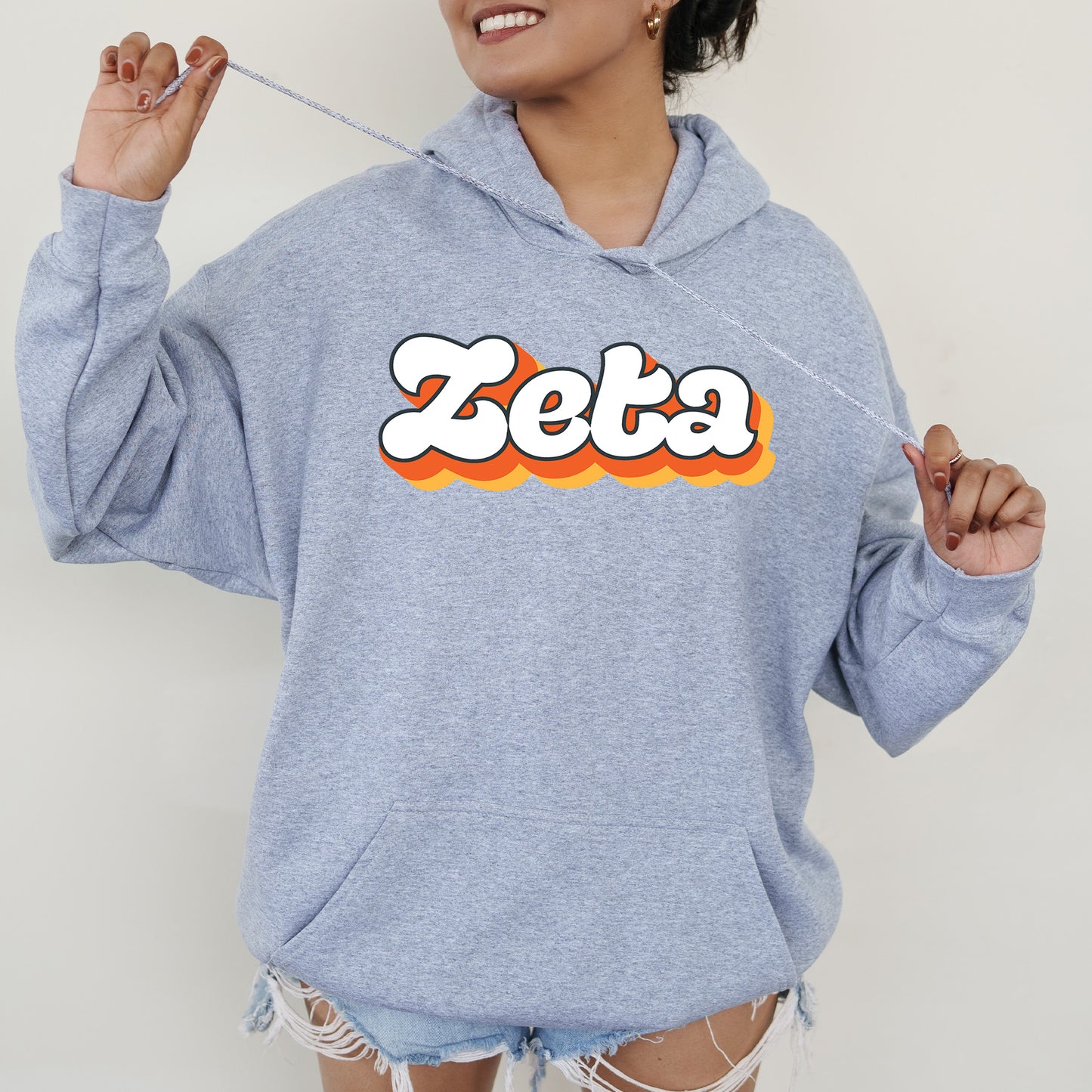 a woman wearing a blue sweatshirt with the word zeba printed on it