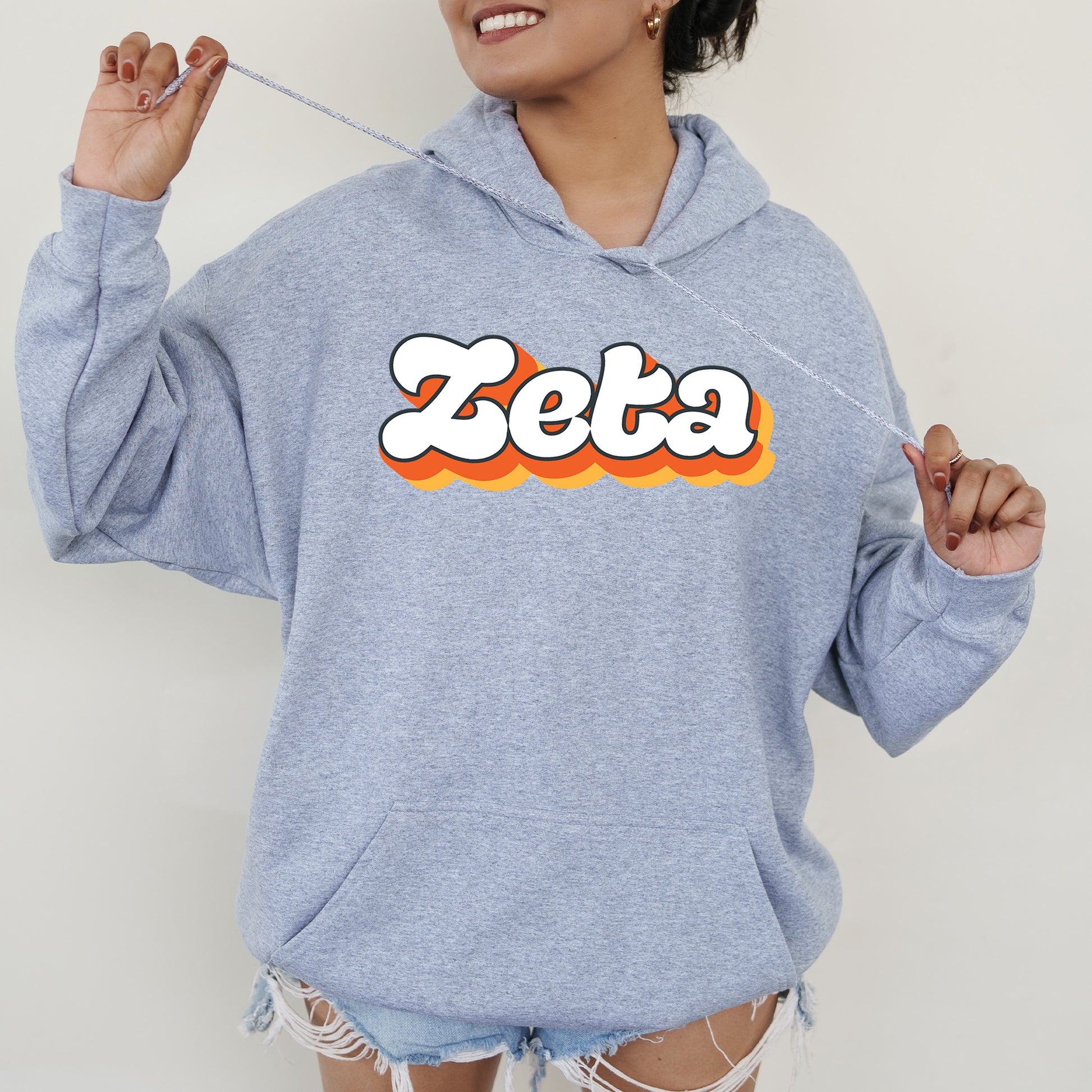 a woman wearing a blue sweatshirt with the word zeba printed on it