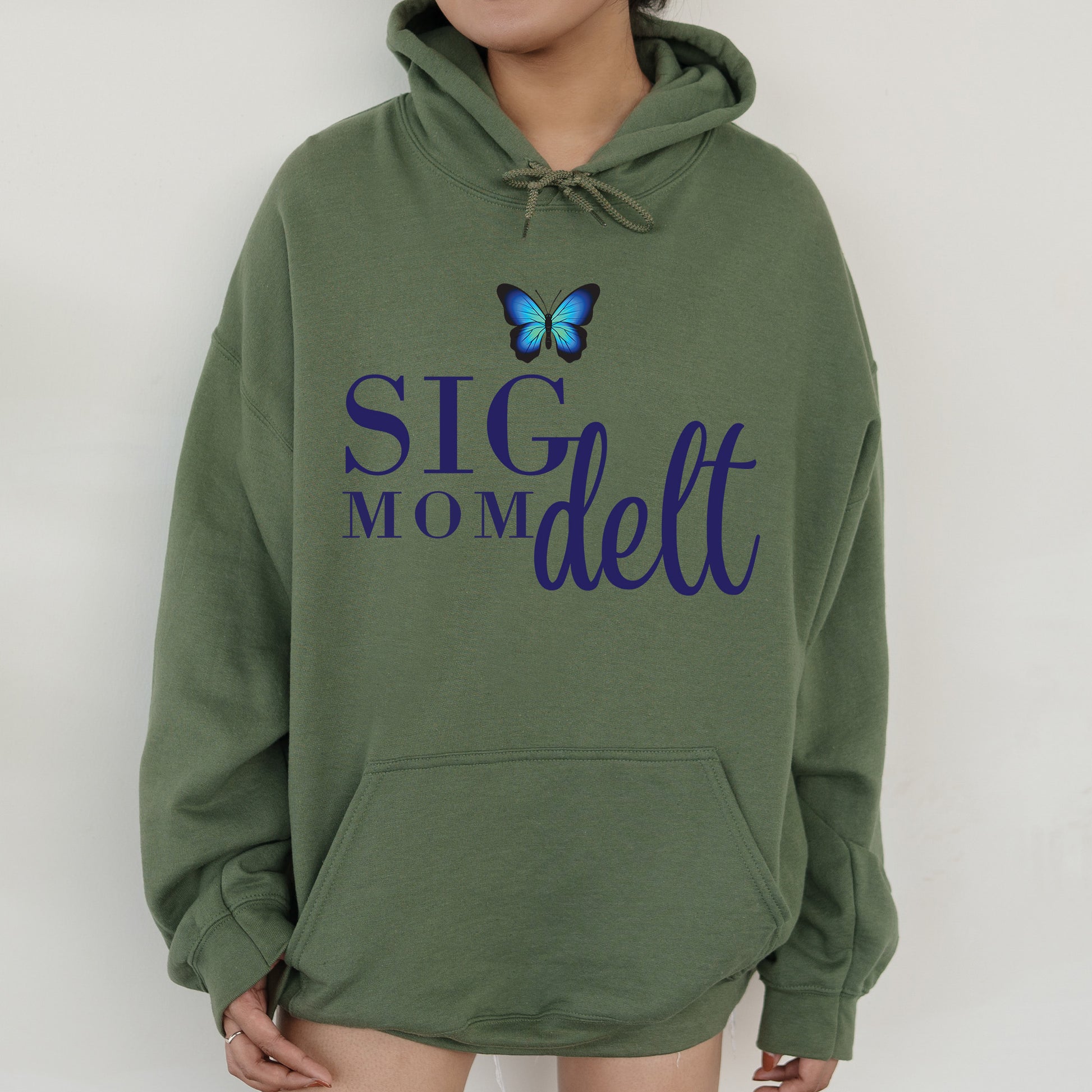 a woman wearing a green hoodie with a butterfly on it