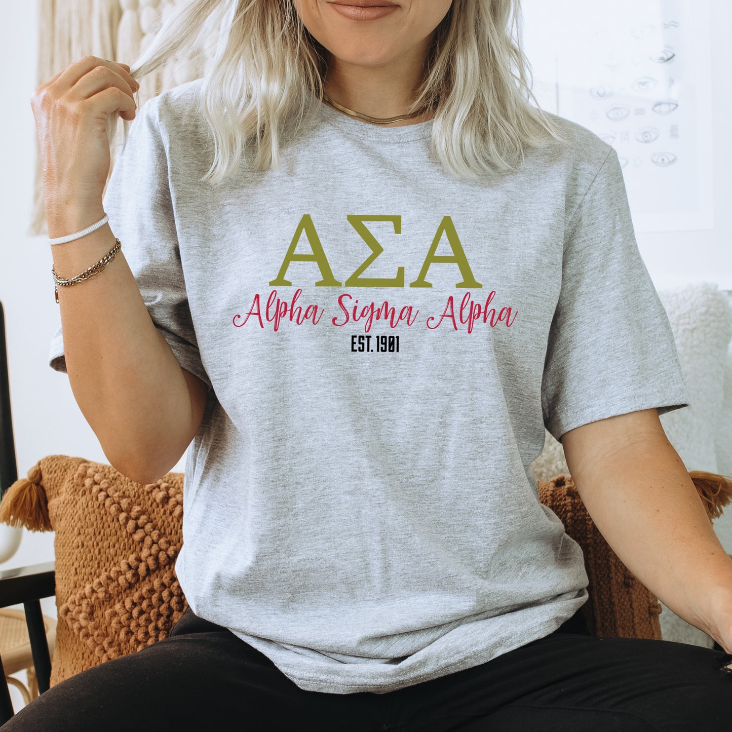 a woman sitting on a chair wearing a t - shirt