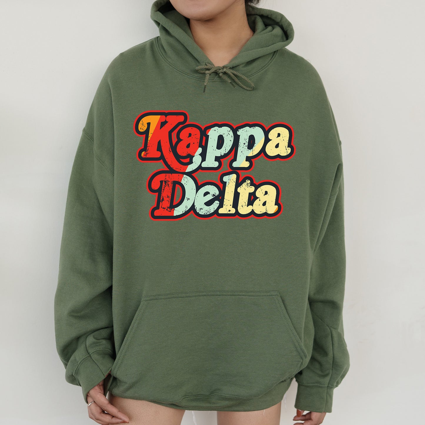 a woman wearing a green hoodie that says kappa delta