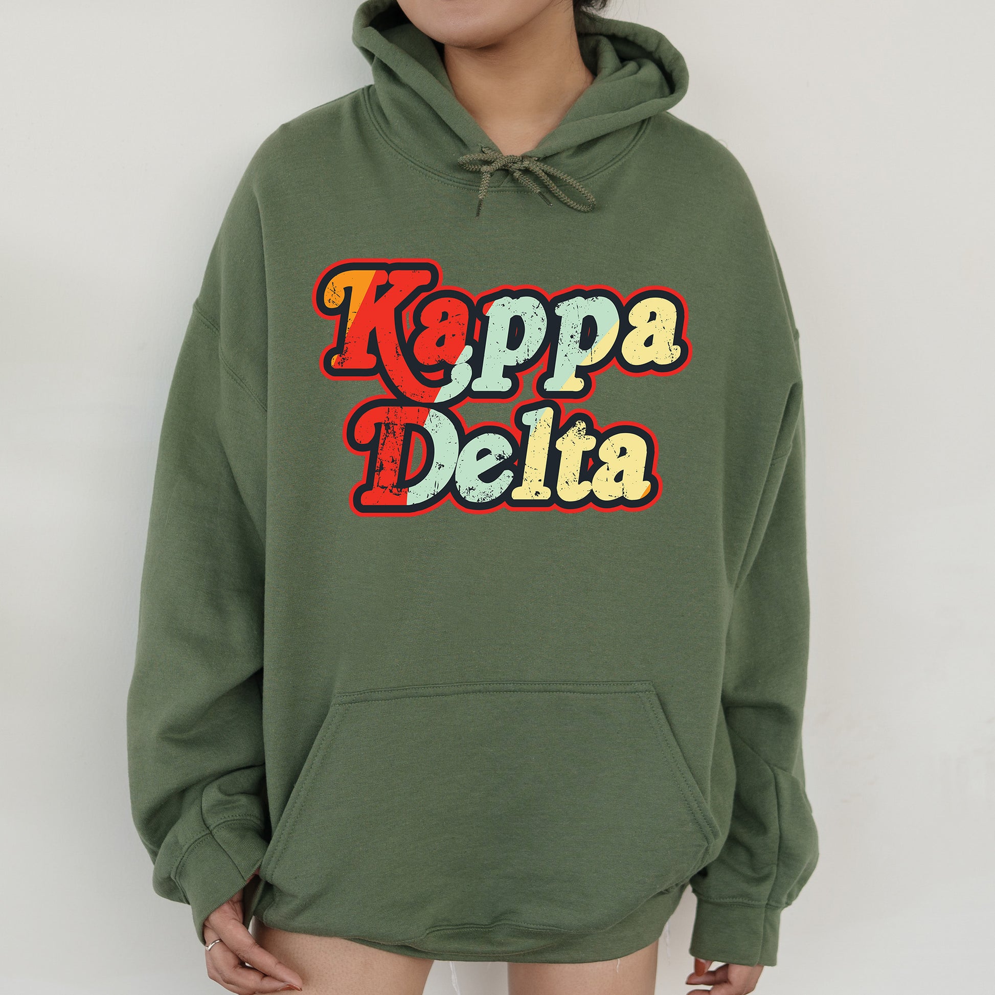 a woman wearing a green hoodie that says kappa delta
