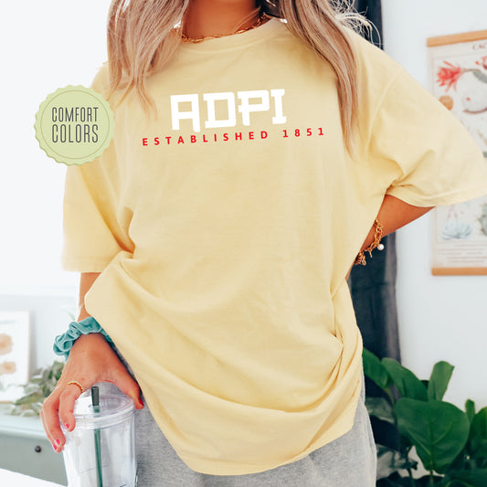 a woman in a yellow shirt holding a blender