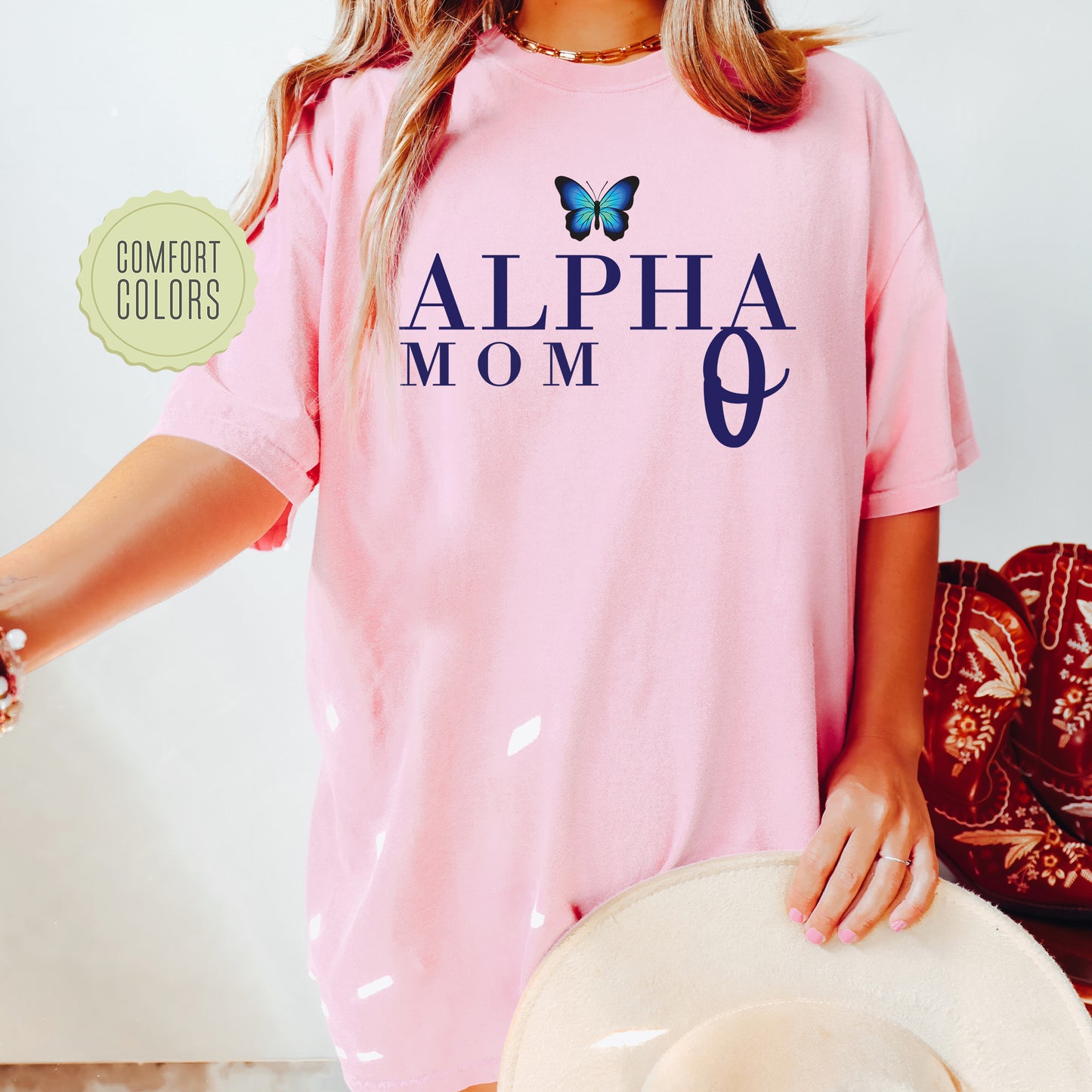 a woman wearing a pink shirt with a butterfly on it