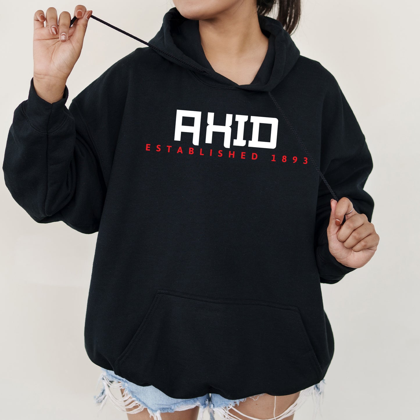 a woman wearing a black hoodie with the word ahd on it
