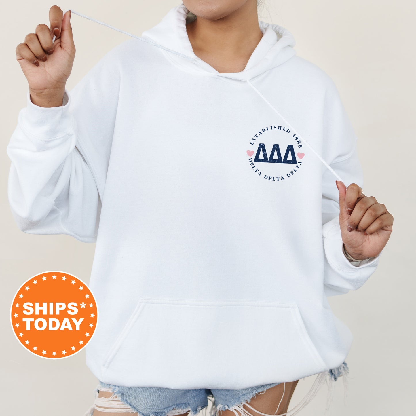 a woman wearing a white hoodie with an aa logo on it