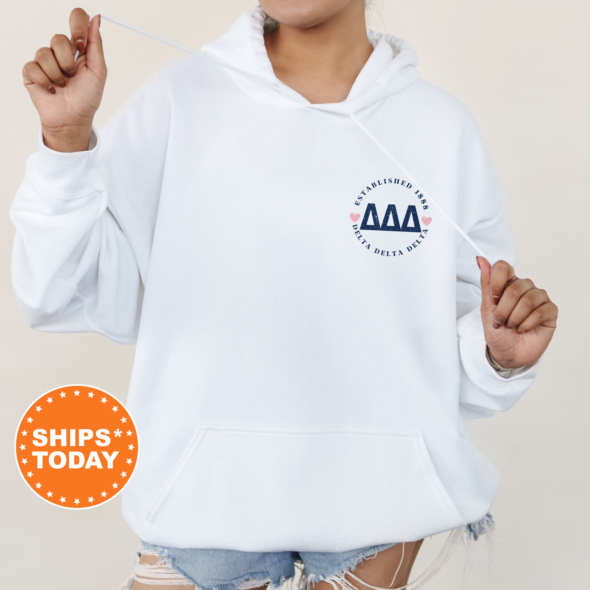 a woman wearing a white hoodie with an aa logo on it
